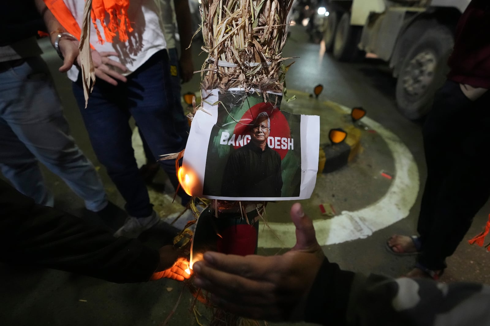 Activists of Bajarang dal, a Hindu rights group, burn an effigy of Bangladesh's interim leader Muhammad Yunus and a symbolic flag of Bangladesh, during a protest against the alleged attacks on Hindus in Bangladesh, in Ahmedabad, India, Wednesday, Dec. 11, 2024. (AP Photo/Ajit Solanki)