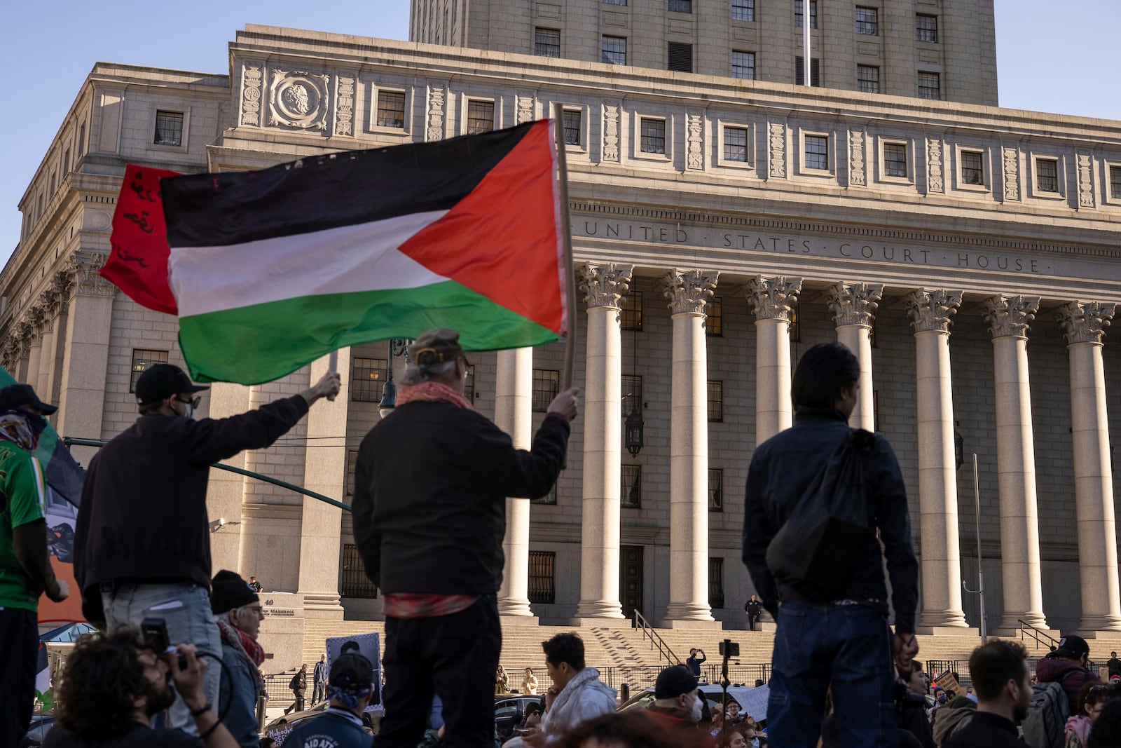 Protesters hold Palestinian flag during a demonstration outside Manhattan Federal Court in support of Palestinian activist Mahmoud Khalil, Monday, March 10, 2025, in New York. (AP Photo/Yuki Iwamura)