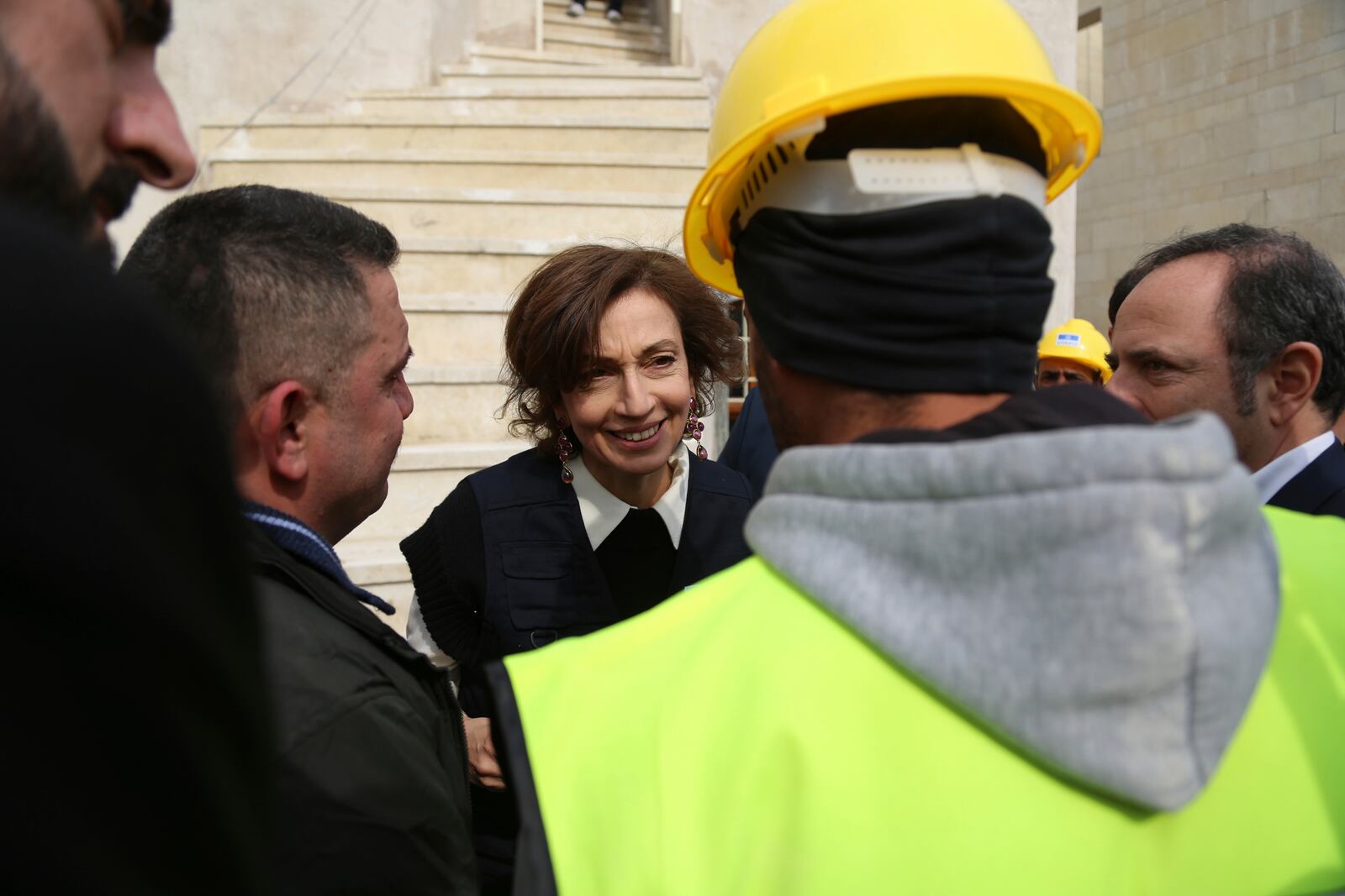 UNESCO Director-General Audrey Azoulay greets workers as she visits historic sites in Mosul, Iraq, Wednesday, Feb. 5, 2025, reconstructed by UNESCO after being damaged in battles with the Islamic State group when it held the city. (AP Photo/Farid Abdulwahed)