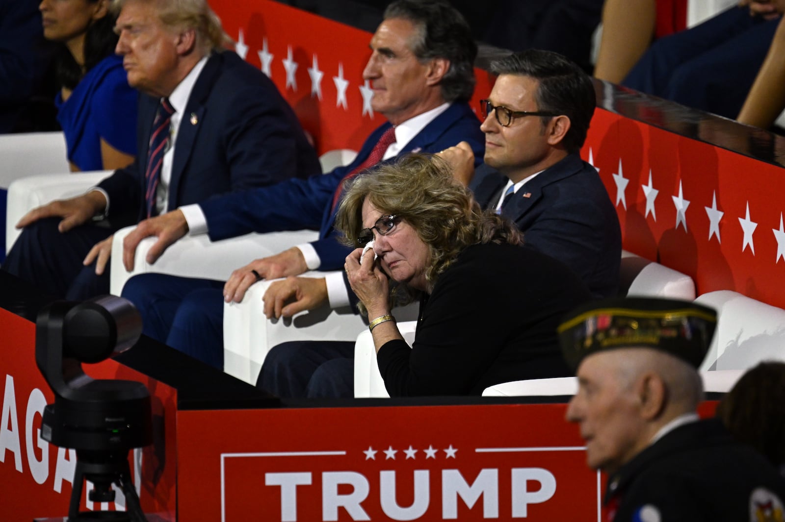 
                        FILE — Beverly Aikins wipes her eye as her son, Sen. JD Vance (R-Ohio) addresses the Republican National Convention in Milwaukee on July 17, 2024. Aikins had never even watched a political convention on television before she was seated at this year’s Republican nominating convention with, from left, former President Donald Trump, Gov. Doug Burgum of North Dakota and House Speaker Mike Johnson (R-La.). (Kenny Holston/The New York Times)
                      