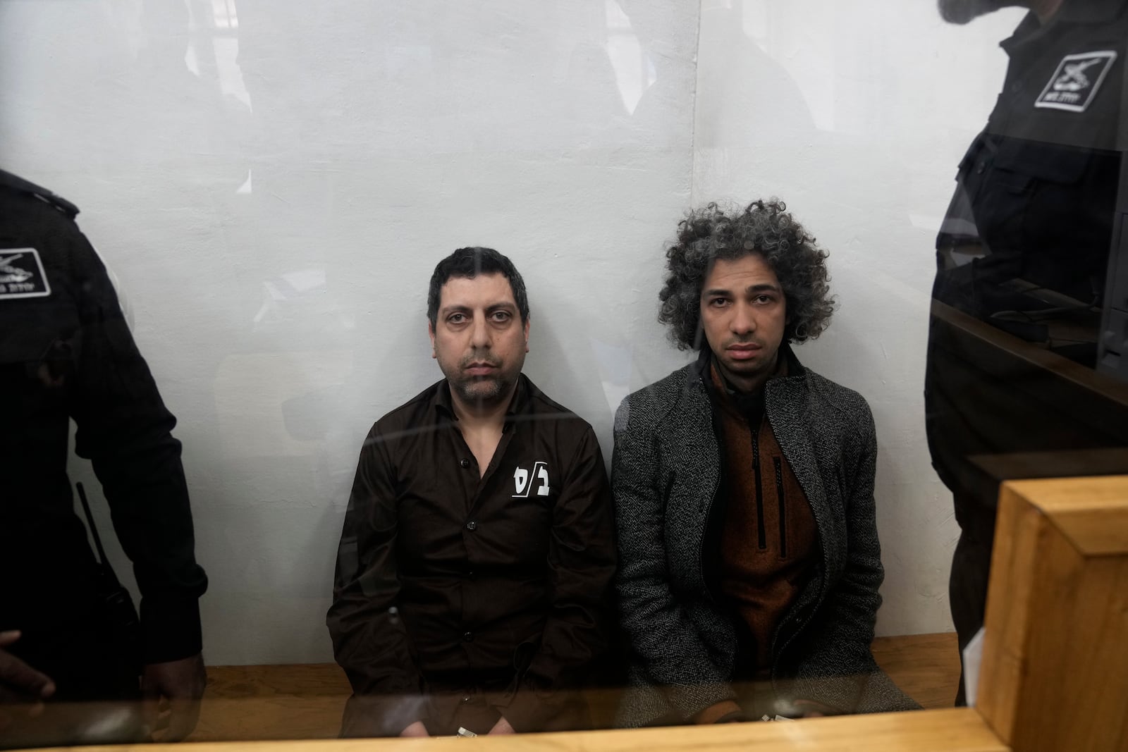 Booksellers Ahmad, left, and Mahmoud Muna appear in court after their arrest during an Israeli police have raid of their long-established Palestinian-owned Educational Bookshop in east Jerusalem, Monday, Feb. 10, 2025. (AP Photo/Mahmoud Illean)