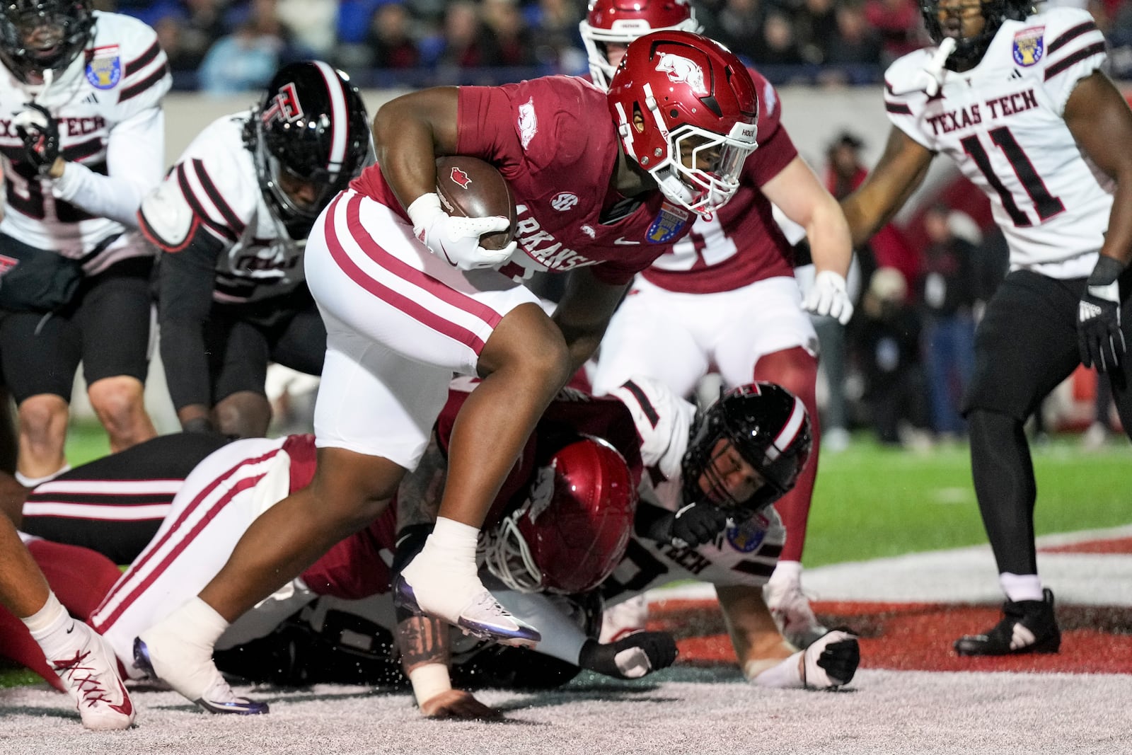 Arkansas running back Braylen Russell runs into the end zone for a touchdown during the first half of the Liberty Bowl NCAA college football game against Texas Tech, Friday, Dec. 27, 2024, in Memphis, Tenn. (AP Photo/George Walker IV)