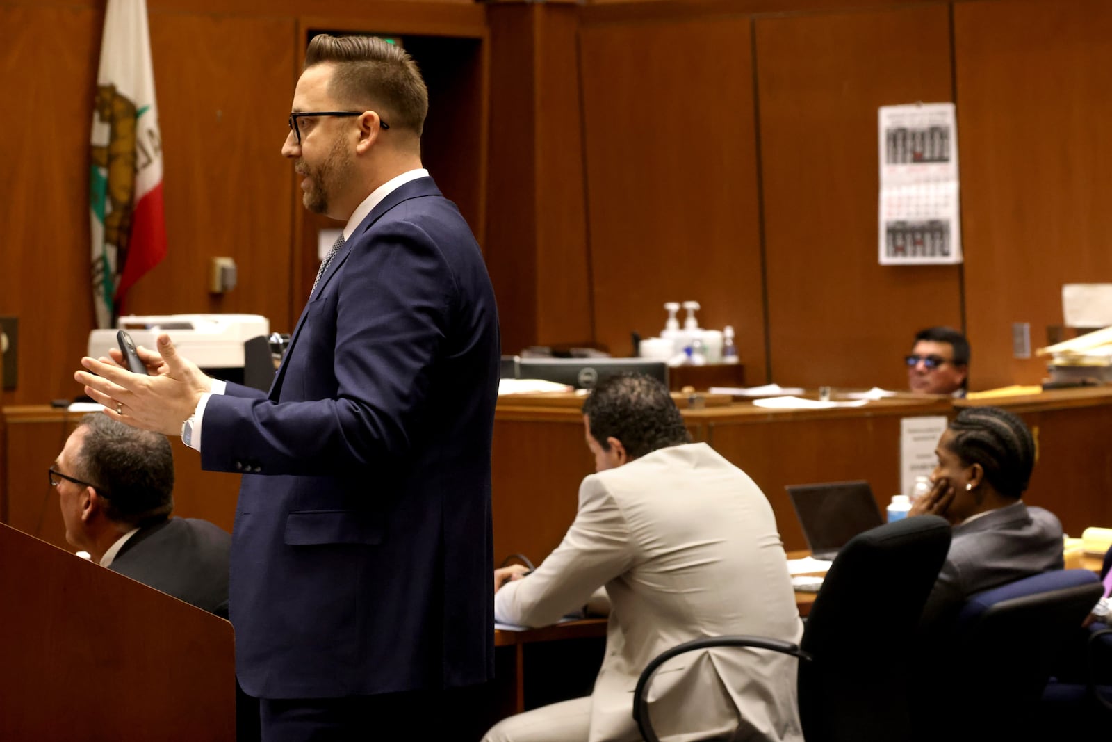 Los Angeles Deputy District Attorney Paul Przelomiec makes his opening remarks as defense attorney Joe Tacopina, center, and his client, Rakim Mayers, aka A$AP Rocky, right, listen in Mayers' trial at the Clara Shortridge Foltz Criminal Justice Center in downtown Los Angeles, Friday, Jan. 24, 2025. (Genaro Molina/Los Angeles Times via AP, Pool)