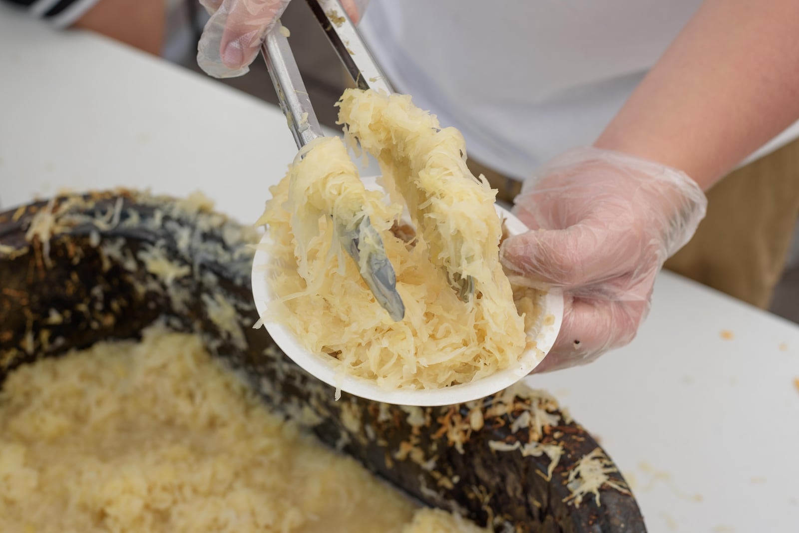 The Ohio Sauerkraut Festival in downtown Waynesville features sauerkraut inspired food including sauerkraut pizza, German sundaes, sauerkraut balls, sauerkraut doughnuts and more. TOM GILLIAM/CONTRIBUTING PHOTOGRAPHER