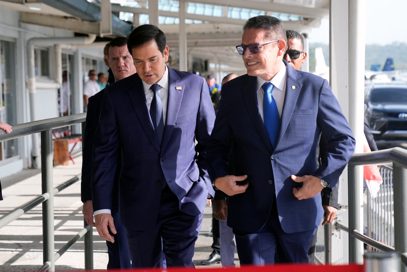 Secretary of State Marco Rubio, left, walks with Panama's Minister of Public Security Frank Alexis Abrego, after watching people board a repatriation flight bound for Colombia at Albrook Airport in Panama City, Monday, Feb. 3, 2025. (AP Photo/Mark Schiefelbein, Pool)