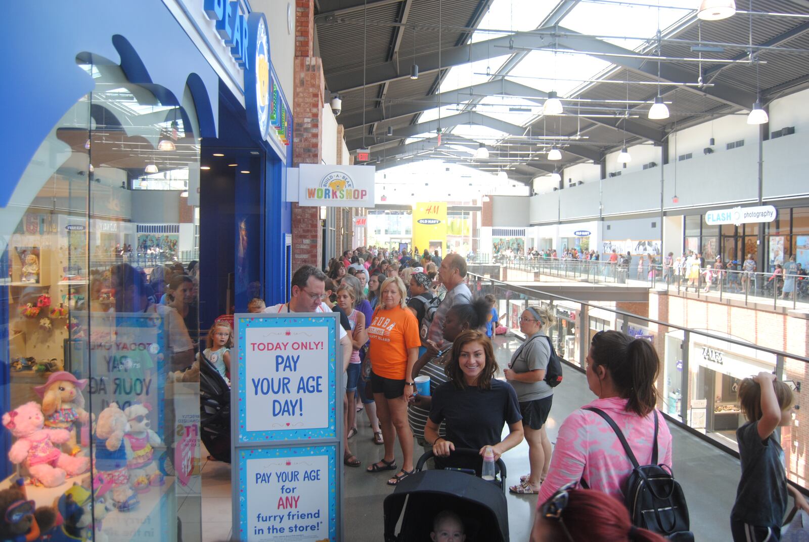 Shoppers wait to enter Build-A-Bear Workshop at Liberty Center on Thursday, July 12, 2018.