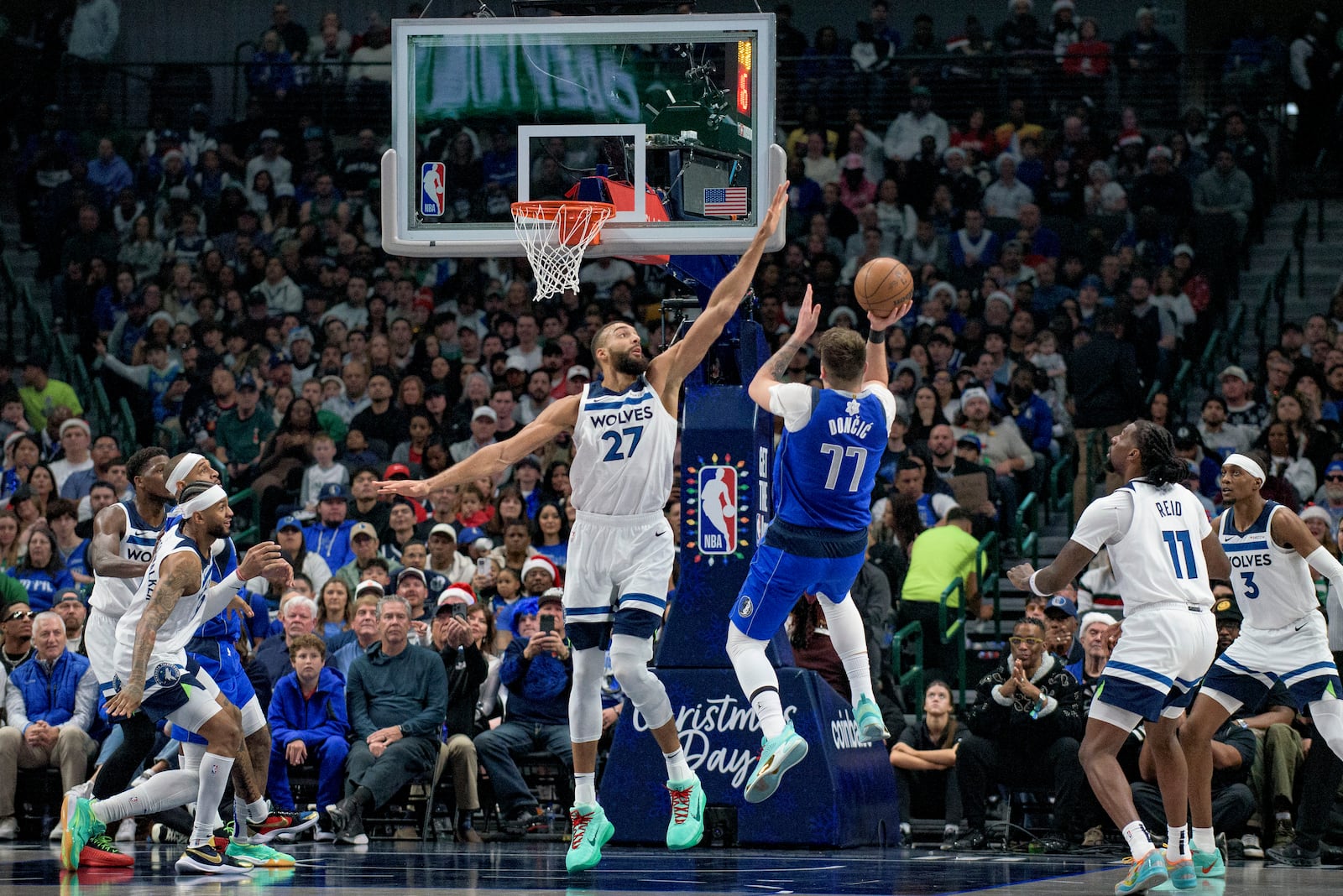 Dallas Mavericks guard Luka Doncic (77) attempts a shot over Minnesota Timberwolves center Rudy Gobert (27) in the first half of an NBA basketball game on Wednesday, Dec. 25, 2024, in Dallas. (AP Photo/Emil T. Lippe)