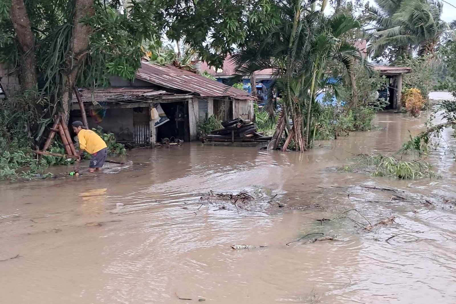 In this photo provided by the Local Government Unit (LGU) of Lal-lo, a resident wades along flooded areas caused by Typhoon Yinxing in Lal-lo, Cagayan province, northern Philippines Friday, Nov. 8, 2024. (LGU Lal-lo via AP)