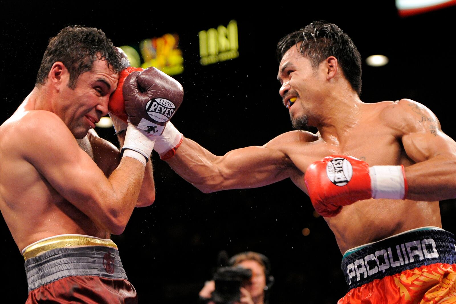 FILE - WBC lightweight champion Manny Pacquiao, right, connects with Oscar De La Hoya during the sixth round of their welterweight boxing match in Las Vegas, Saturday, Dec. 6, 2008. (AP Photo/Mark J. Terrill, File)