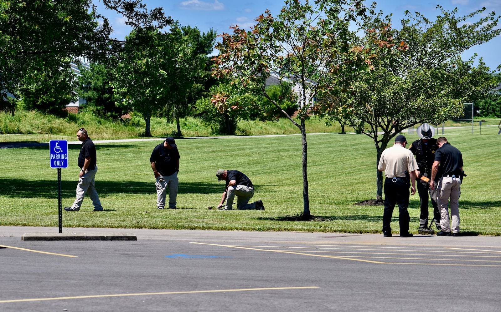 Investigators search Liberty Park in Liberty Twp. for evidence after a fatal shooting there on Wednesday night, June 10, 2020. NICK GRAHAM / STAFF