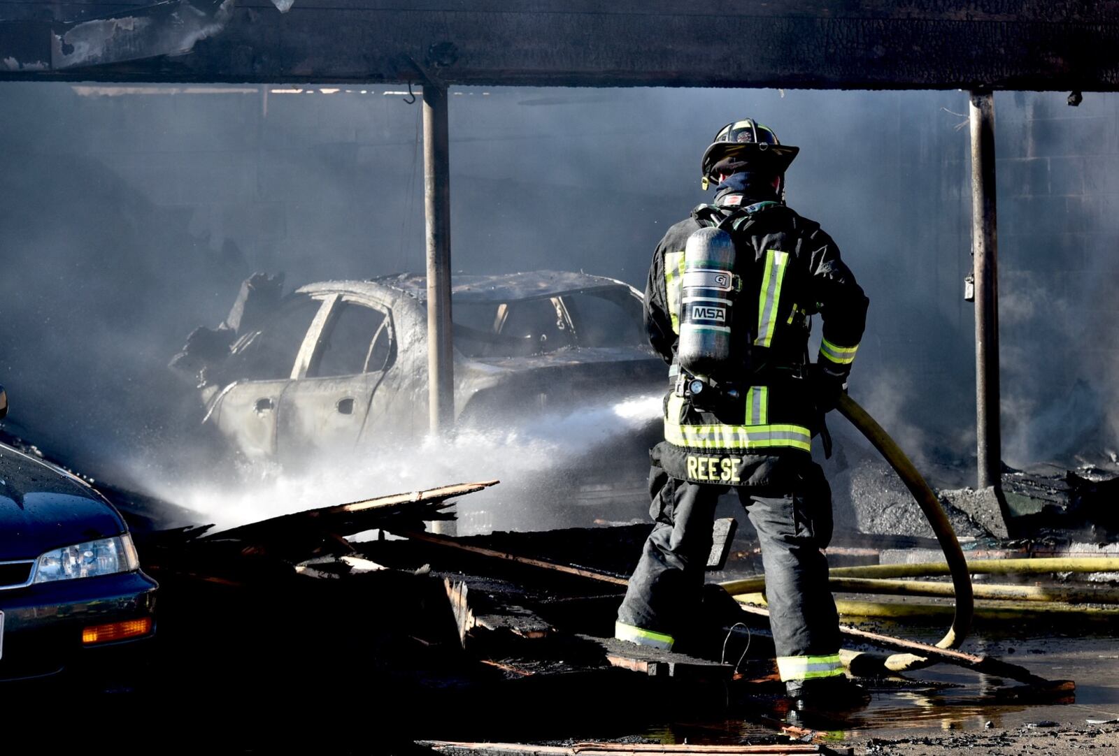 Several cars were heavily burned in a fire at a garage behind apartments on Arlington Avenue in Hamilton on Monday, Feb. 25, 2019. NICK GRAHAM / STAFF