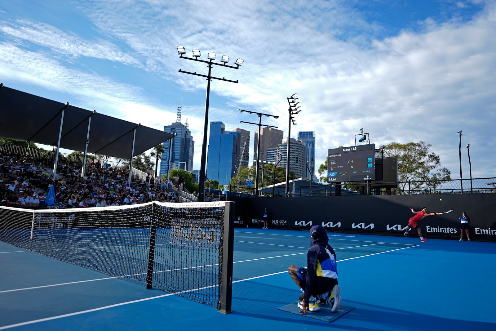 Bu Yunchaokete of China plays a backhand return to Hady Habib of Lebanon during their first round match at the Australian Open tennis championship in Melbourne, Australia, Sunday, Jan. 12, 2025. (AP Photo/Asanka Brendon Ratnayake)