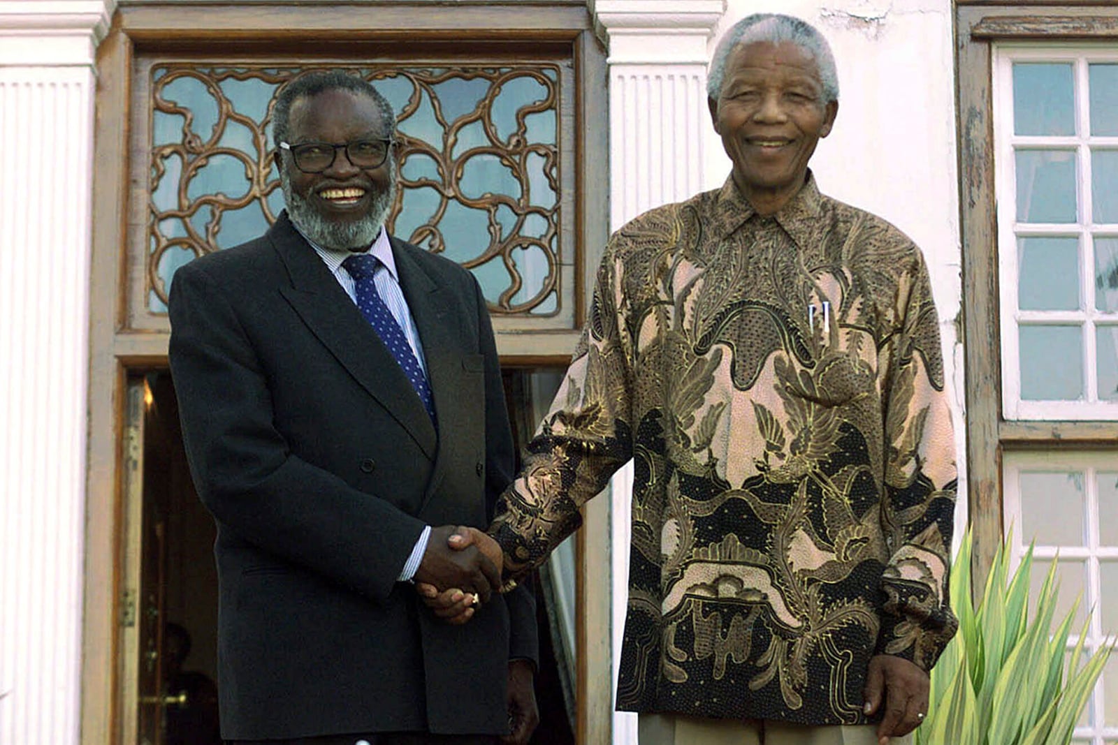 FILE - South African President Nelson Mandela, right, shakes hands with Namibian President Sam Nujoma at the presidential residence in Pretoria, South Africa, June 1, 1999, on the eve of the country's second all-race elections. (AP Photo/Jean-Marc Bouju, File)