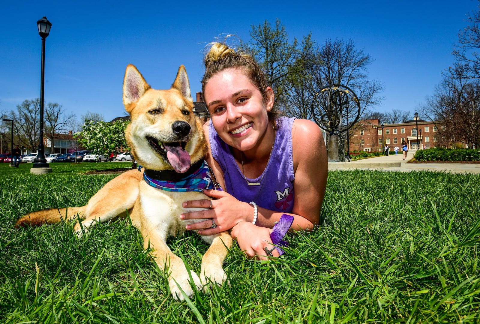 Miami University sophomore Paige Hepner sits with her Emotional Support dog, Arlo, Wednesday, April 12 on the Miami University Campus in Oxford. 