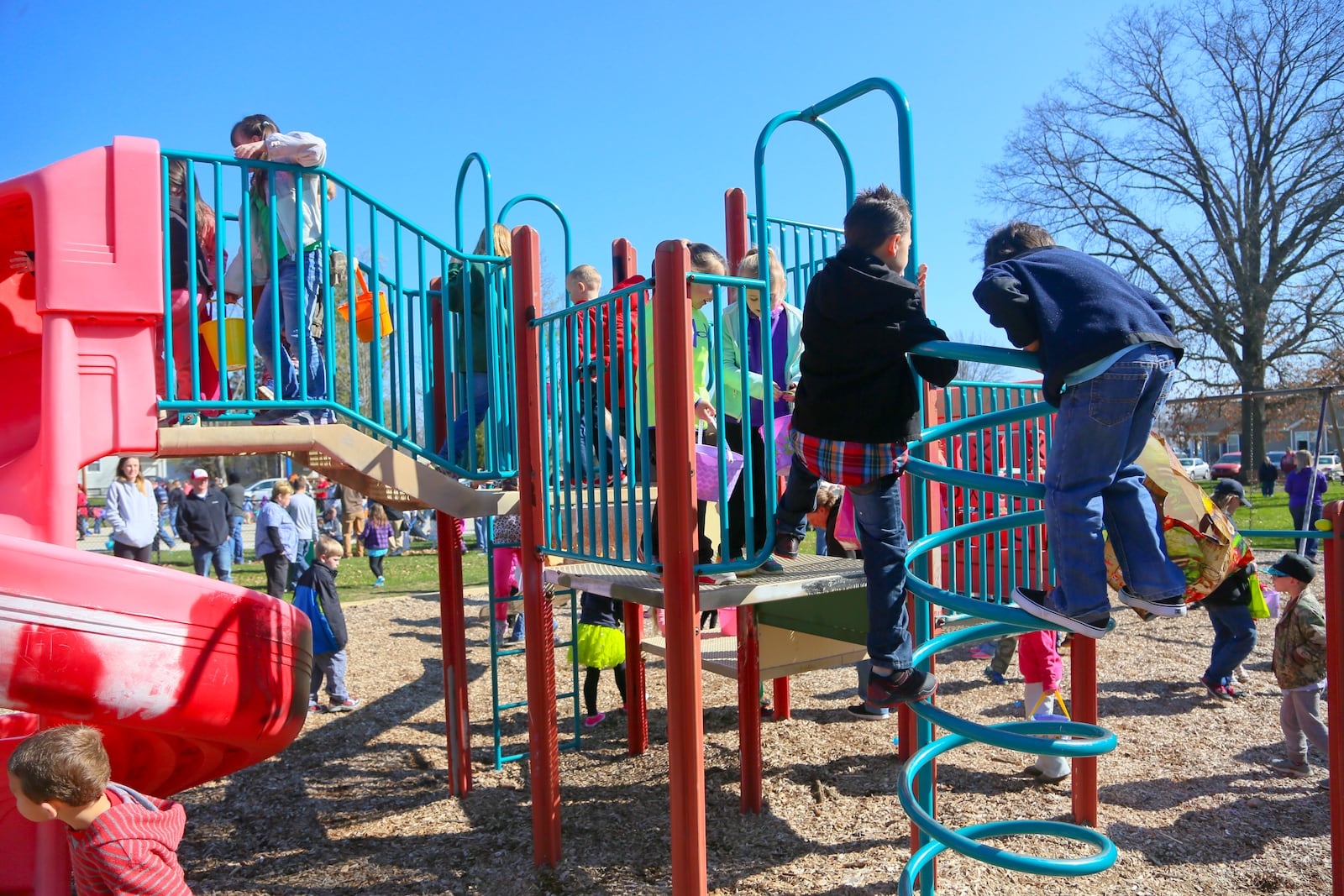 Children search the playset for hidden Easter eggs during the Easter egg hunt last year at the Lindenwald splash pad at Benninghofen playground in Hamilton. This year’s egg hunt is set for April 8. GREG LYNCH / STAFF