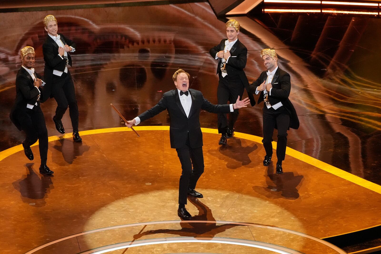 Host Conan O'Brien, center, performs during the Oscars on Sunday, March 2, 2025, at the Dolby Theatre in Los Angeles. (AP Photo/Chris Pizzello)