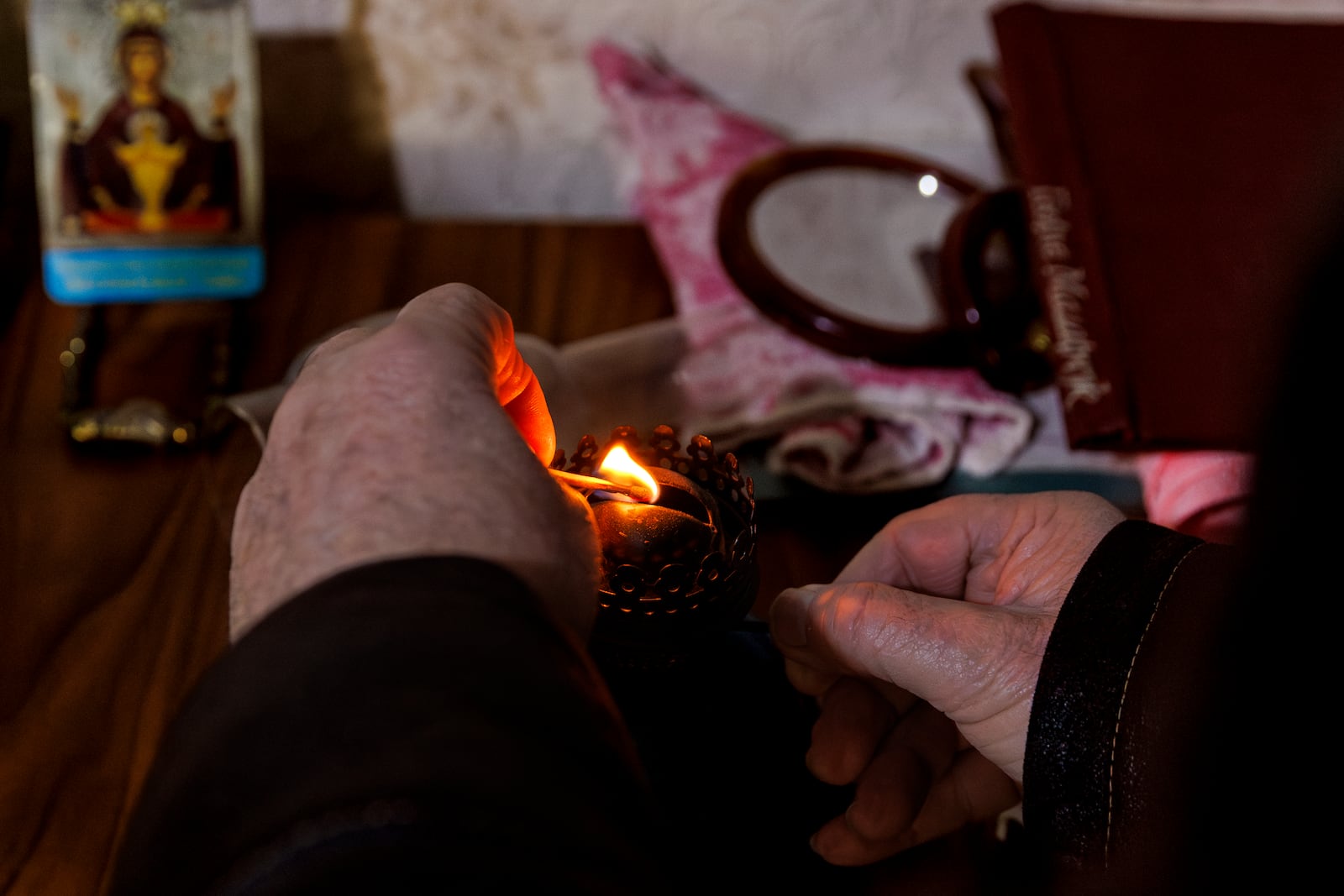 Retired teacher Vasile Donici lights a gas lamp in his home in Copanca, Moldova, Wednesday, Jan. 8, 2025. (AP Photo)