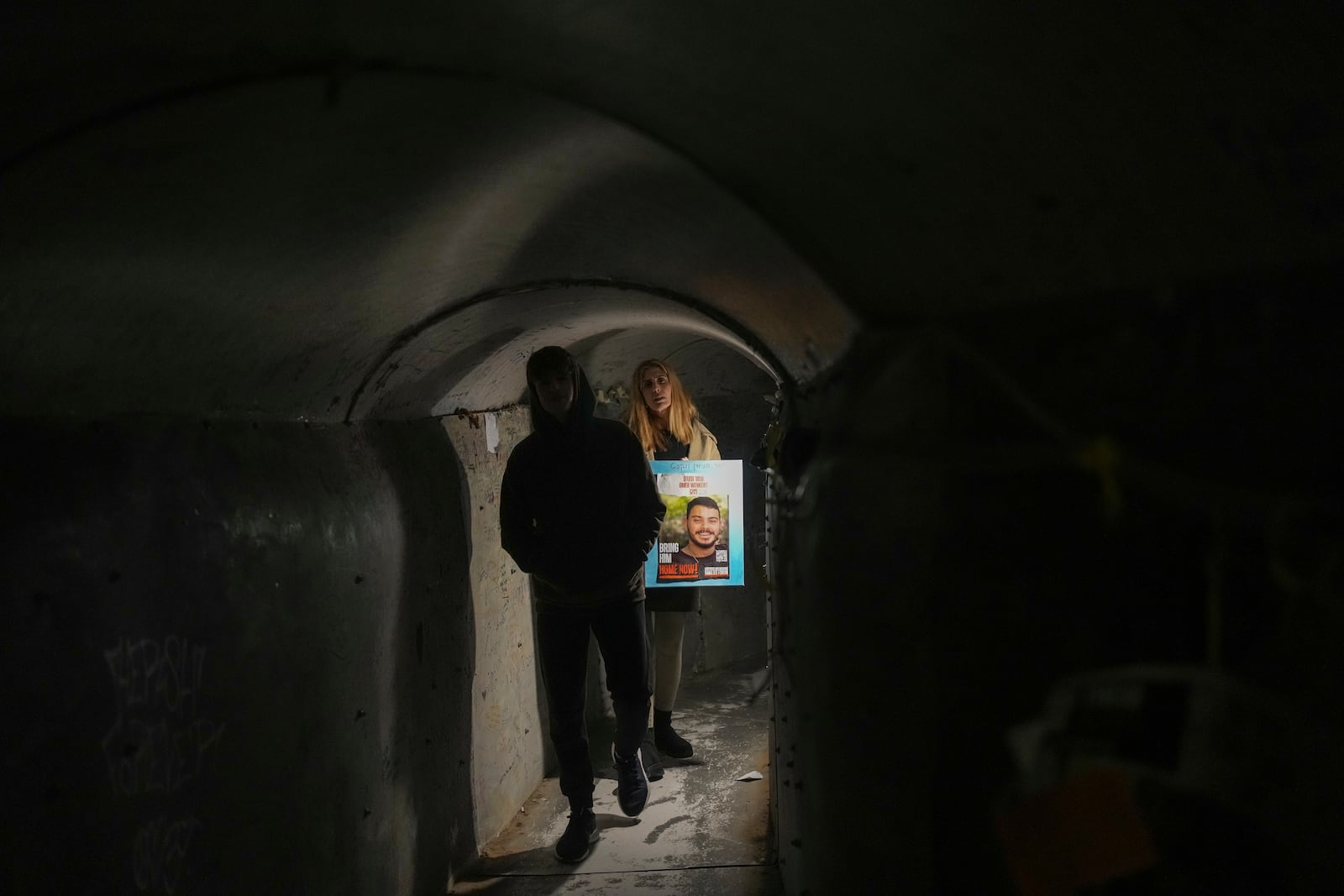 Two women walk through an installation simulating a tunnel in Gaza in an act of solidarity with hostages believed to be held underground by Hamas before a weekly demonstration calling for their return, in Tel Aviv, Israel, Saturday Jan. 18, 2025.(AP Photo/Maya Alleruzzo)