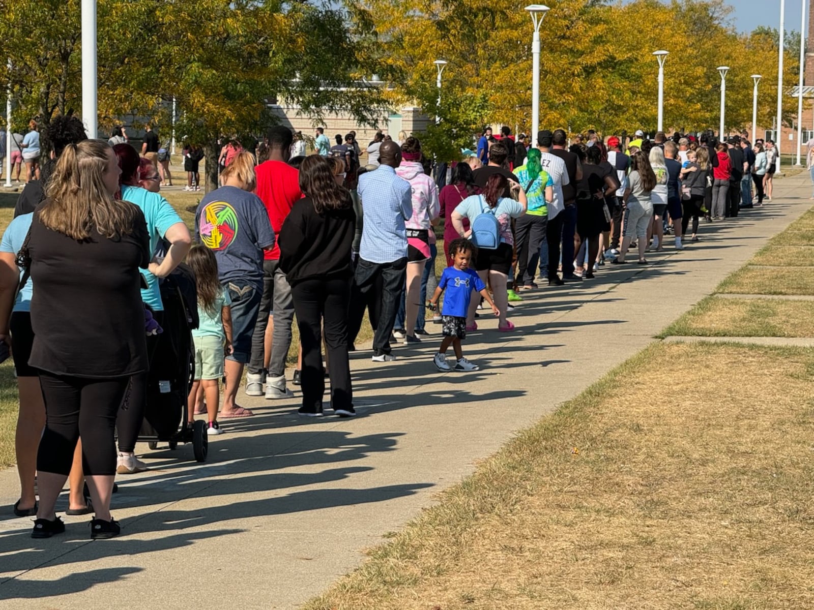 Parents wait in line at Springfield High School to pick up Simon Kenton Elementary students after a bomb threat on Monday, Sept. 16. BILL LACKEY/STAFF