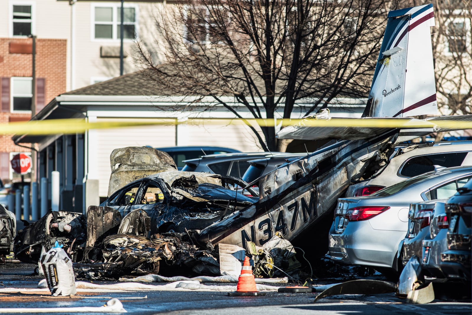 Debris is seen after a plane crashed in a parking lot of a retirement community Sunday, March 9, 2025, in Manheim Township, Pa. (Zach Gleiter/The Patriot-News via AP)