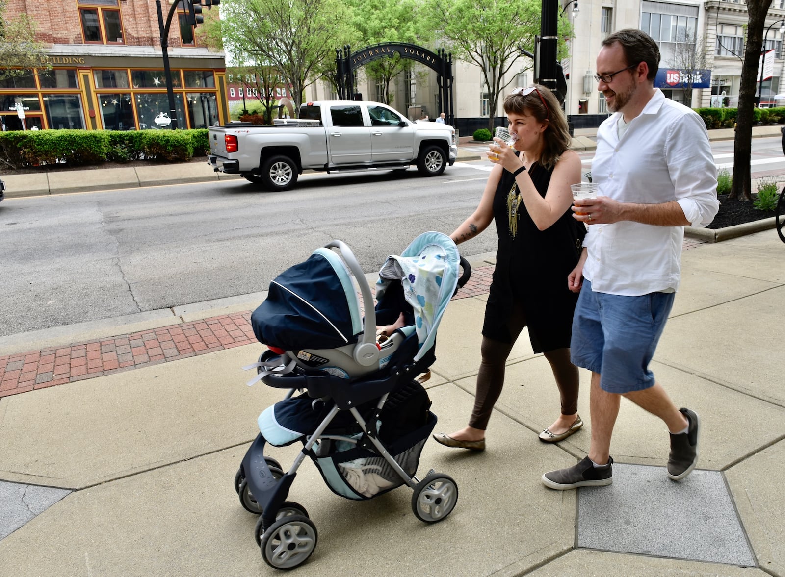 Jennifer Acus-Smith and Stephen Smith walk down the sidewalk on High Street on the first day of Hamilton’s Downtown Outdoor Refreshment Area (D.O.R.A.) Thursday, May 3.