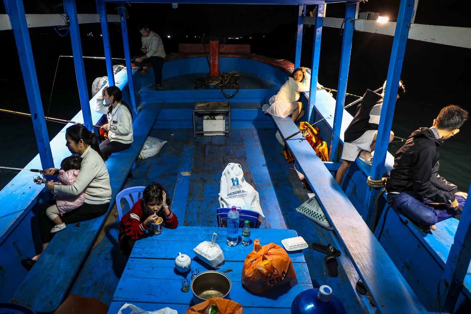 Members of the Tran family fish off Hon Tam Island on Feb. 7, 2025, in Nha Trang, Vietnam. (AP Photo/Yannick Peterhans)