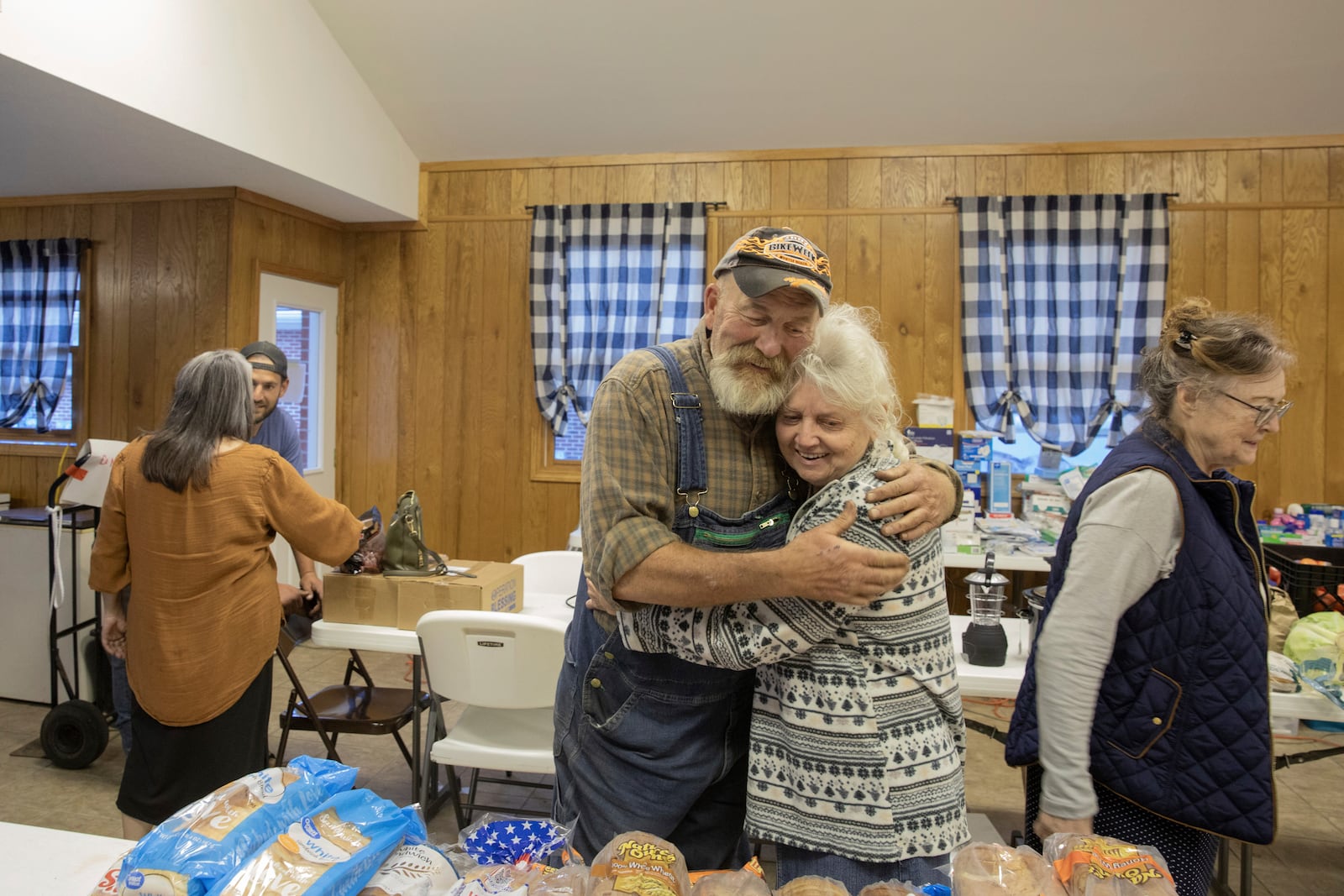 Friends hug at a resource hub operating out of the Beans Creek Church of the Lord Jesus Christ in Bakersville, N.C. on Oct. 9, 2024. (AP Photo/Gabriela Aoun Angueria)