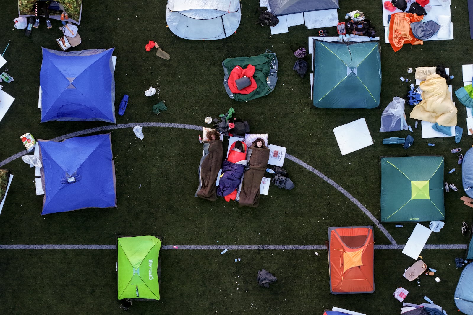 An aerial view of students sleeping in their tents on a soccer stadium as they take part in a march and protest over the collapse of a concrete canopy that killed 15 people more than two months ago, in Indjija, Serbia, Friday, Jan. 31, 2025. (AP Photo/Armin Durgut)