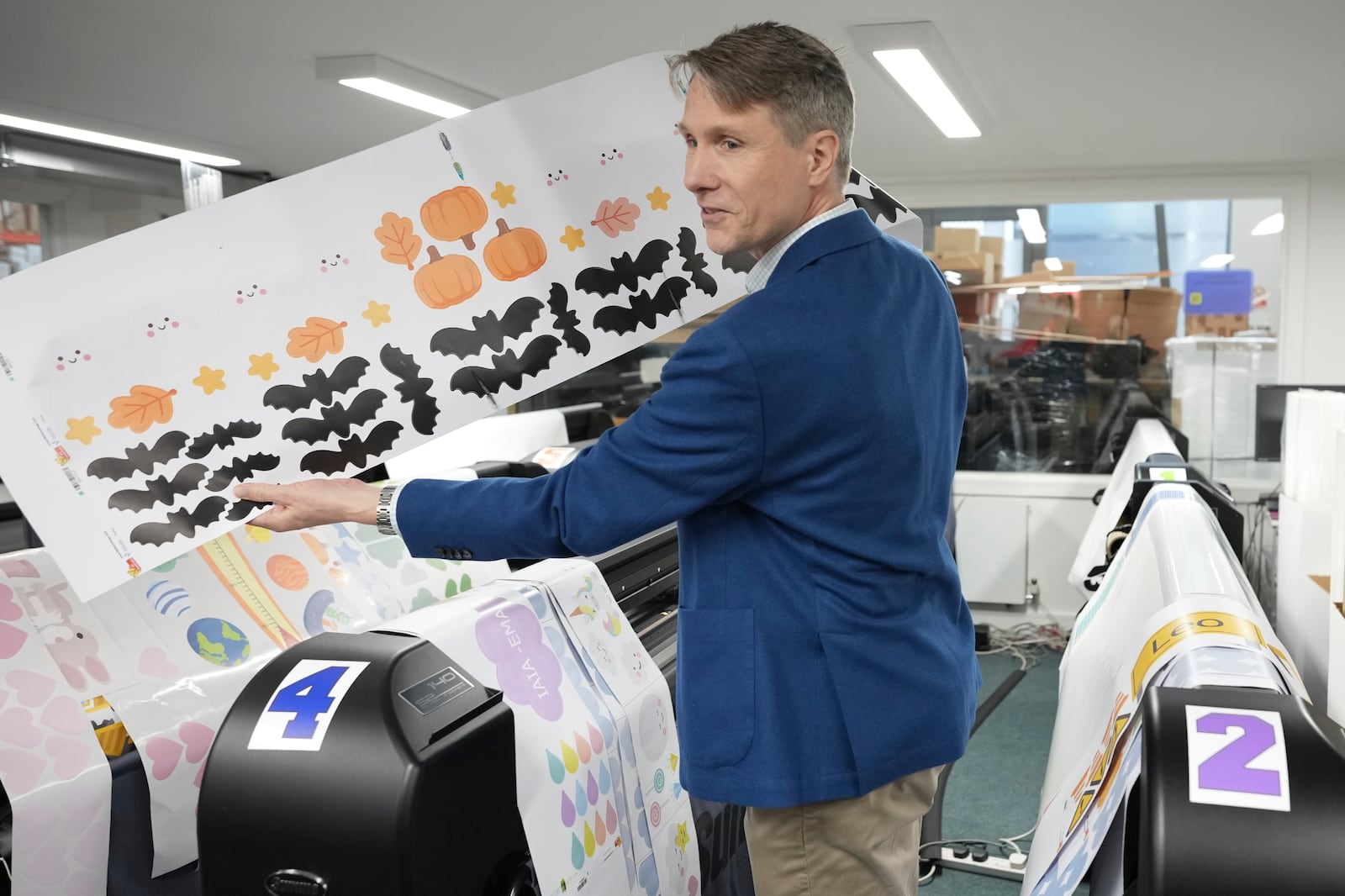 Lars Andersen founder of 'My Nametags' speaks during an interview at his factory in London, Thursday, Jan. 30, 2025. (AP Photo/Alastair Grant)