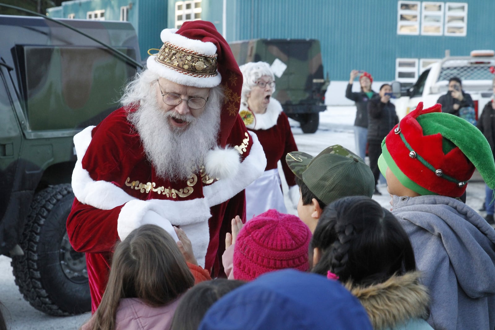 Santa Claus meets children after arriving at the school in Yakutat, Alaska, as part of the Alaska National Guard's Operation Santa initiative that brings Christmas to an Indigenous community that has suffered a hardship, Wednesday, Dec. 18, 2024. (AP Photo/Mark Thiessen).