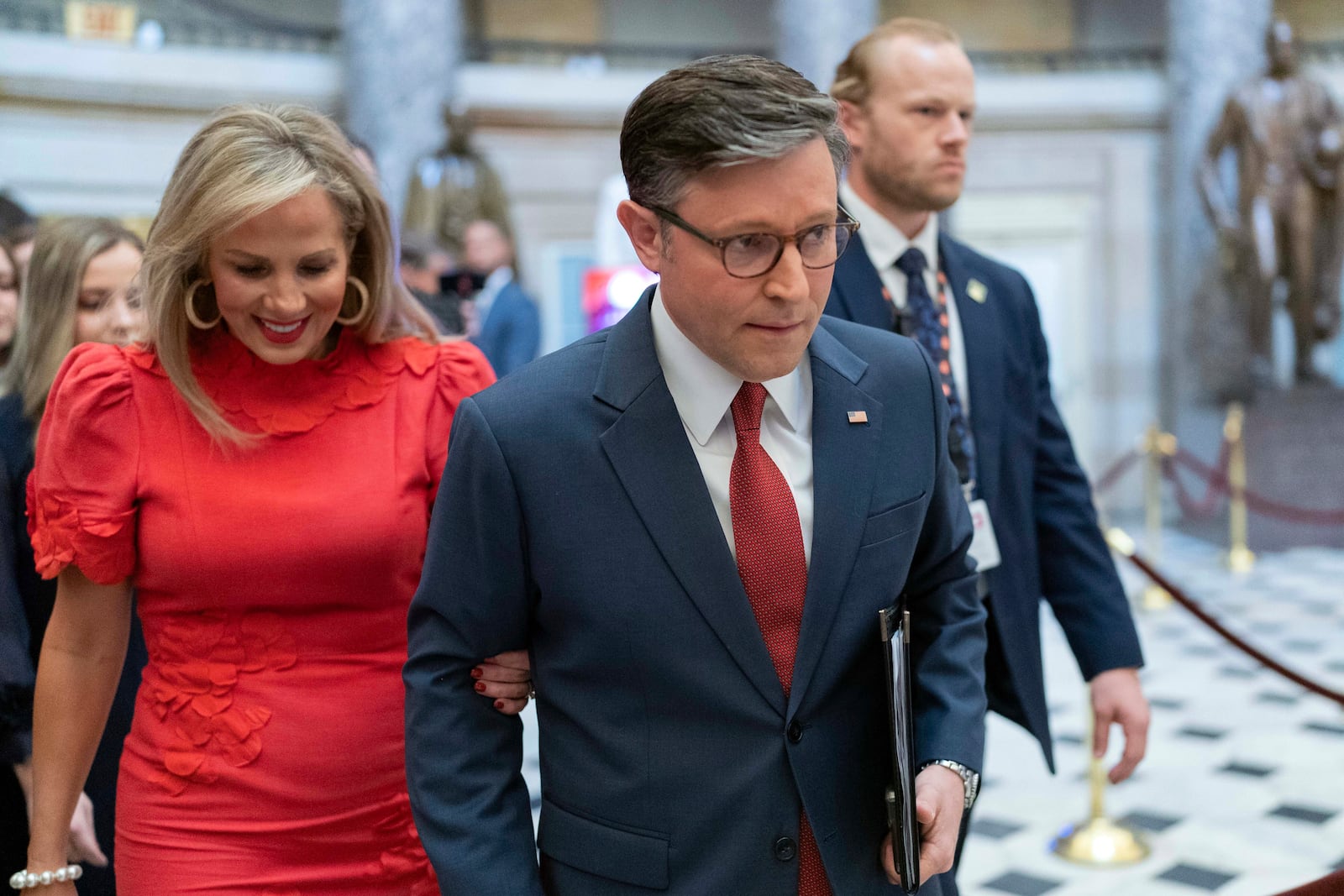 Speaker of the House Mike Johnson, R-La., accompanied by his wife Kelly Johnson, left, walks to the House Chamber before starting the 119th United States Congress at the Capitol in Washington, Friday, Jan. 3, 2025. (AP Photo/Jose Luis Magana)