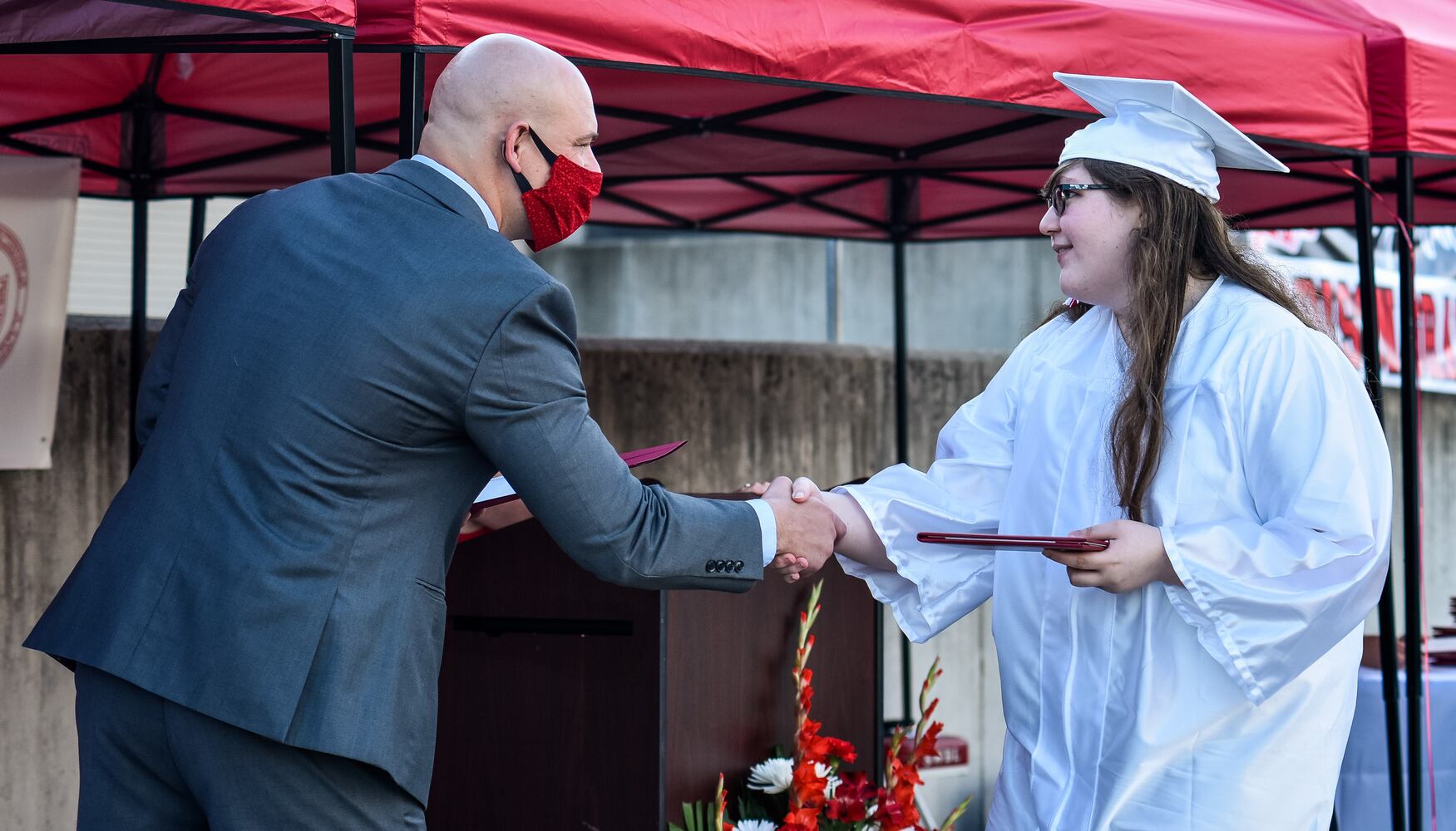 Madison High School drive-thru graduation ceremony at Land of Illusion