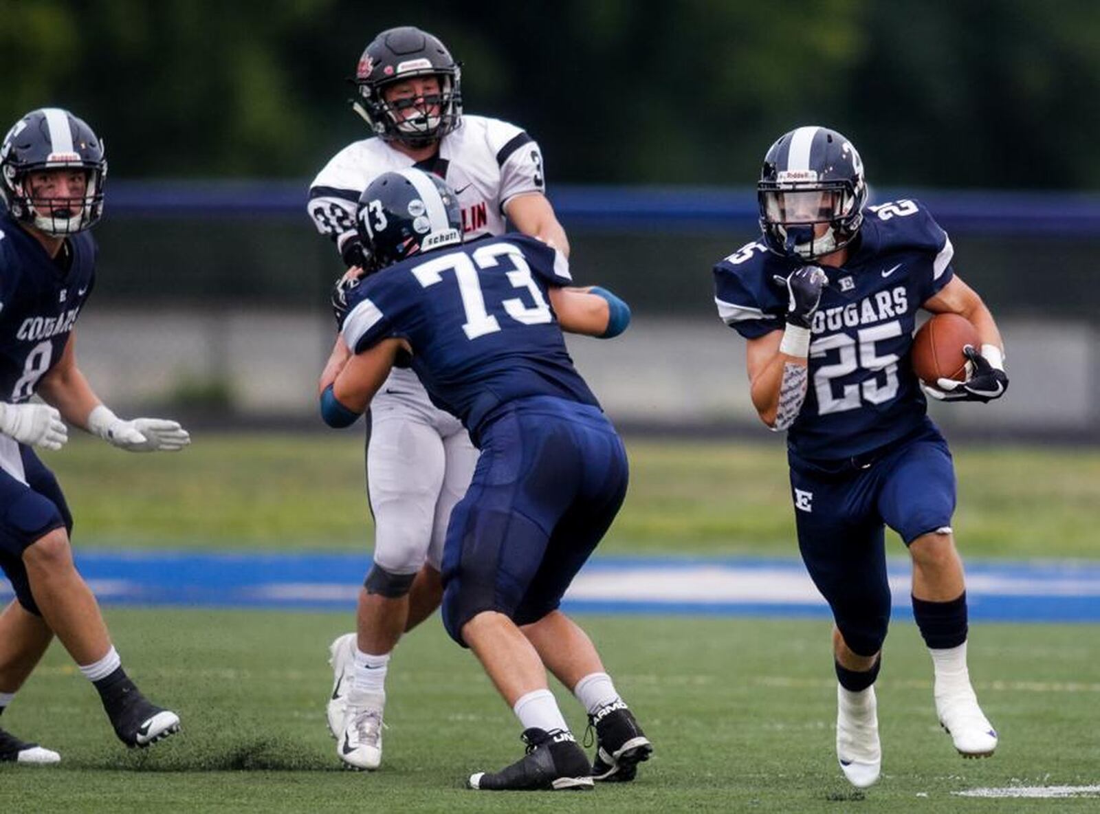 Edgewood’s Wade Phillips (25) is able to get free thanks to a block from teammate Isaac Hamilton (73) on Franklin’s Matt Centers on Friday night at Kumler Field in St. Clair Township. NICK GRAHAM/STAFF