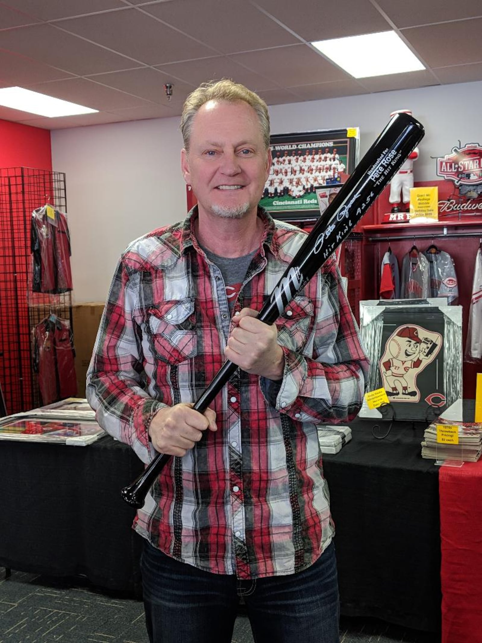 Mark Fugate, owner of Sports Gallery in Forest Park, holds a black Marucci bat, handcrafted for Pete Rose. The bat allegedly was stolen from the store Monday afternoon, then returned after the shoplifters were apprehended in the parking lot. Rose, Major League Baseball's all-time Hit King, was in the store signing autographs at the time of the theft.