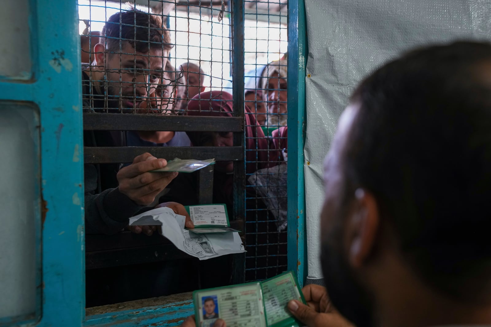 FILE - Palestinians line up to receive aid distributed by UNRWA, the U.N. agency helping Palestinian refugees, in Nusairat refugee camp, Gaza, on Nov. 5, 2024. (AP Photo/Abdel Kareem Hana, File)