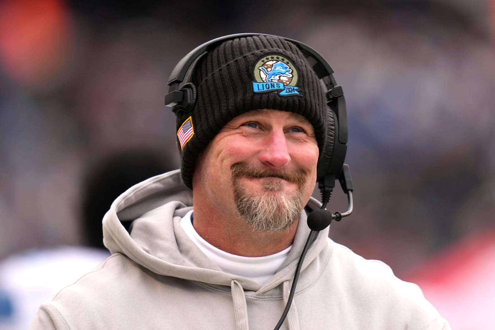 Detroit Lions head coach Dan Campbell smiles along the sidelines during the first half of an NFL football game against the Chicago Bears on Sunday, Dec. 22, 2024, in Chicago. (AP Photo/Erin Hooley)