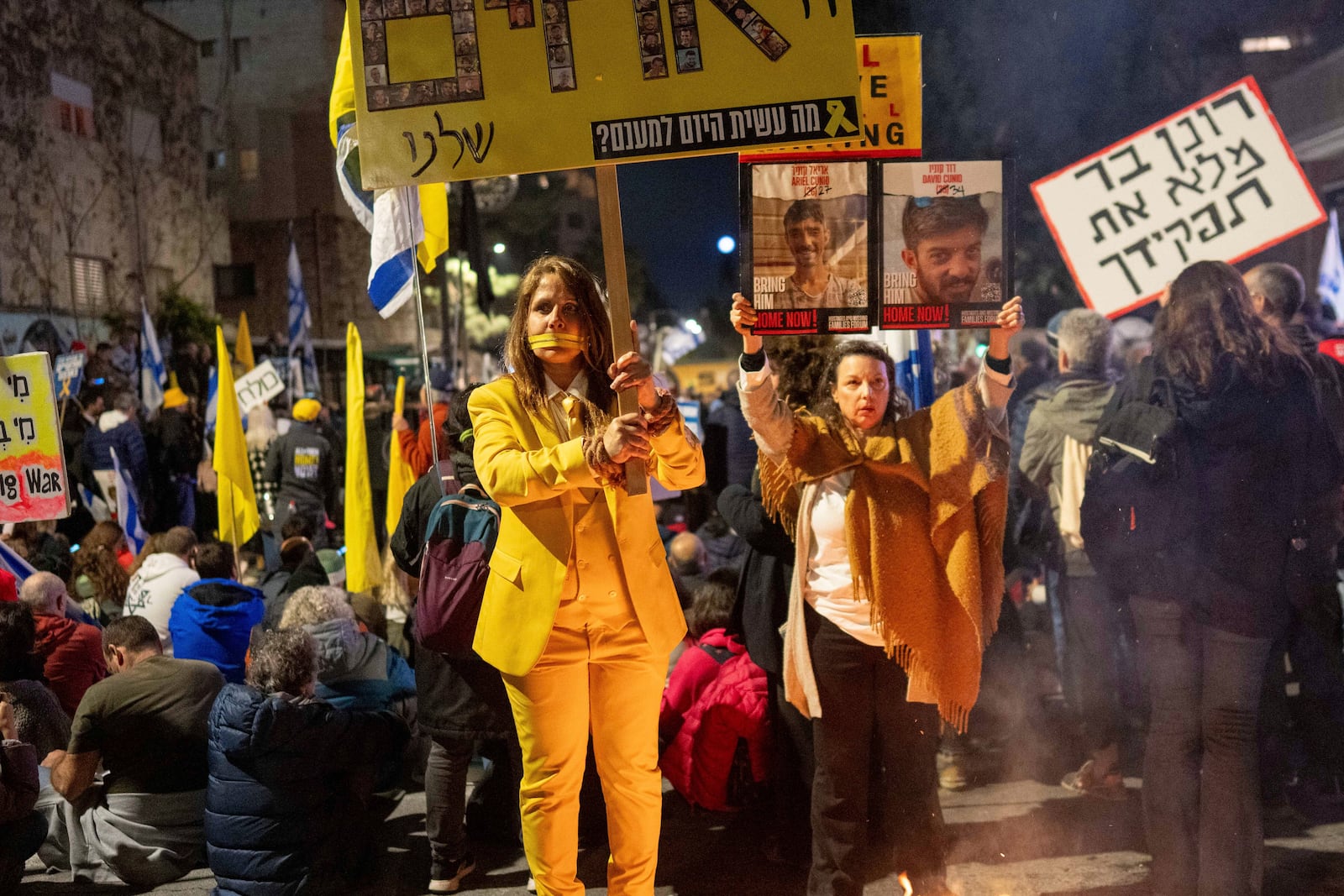 Israelis take part in a protest against Israeli Prime Minister Benjamin Netanyahu's government, and the release of the hostages held in the Gaza Strip by the Hamas militant group, in Jerusalem,Sunday, March 2, 2025. (AP Photo/Ohad Zwigenberg)