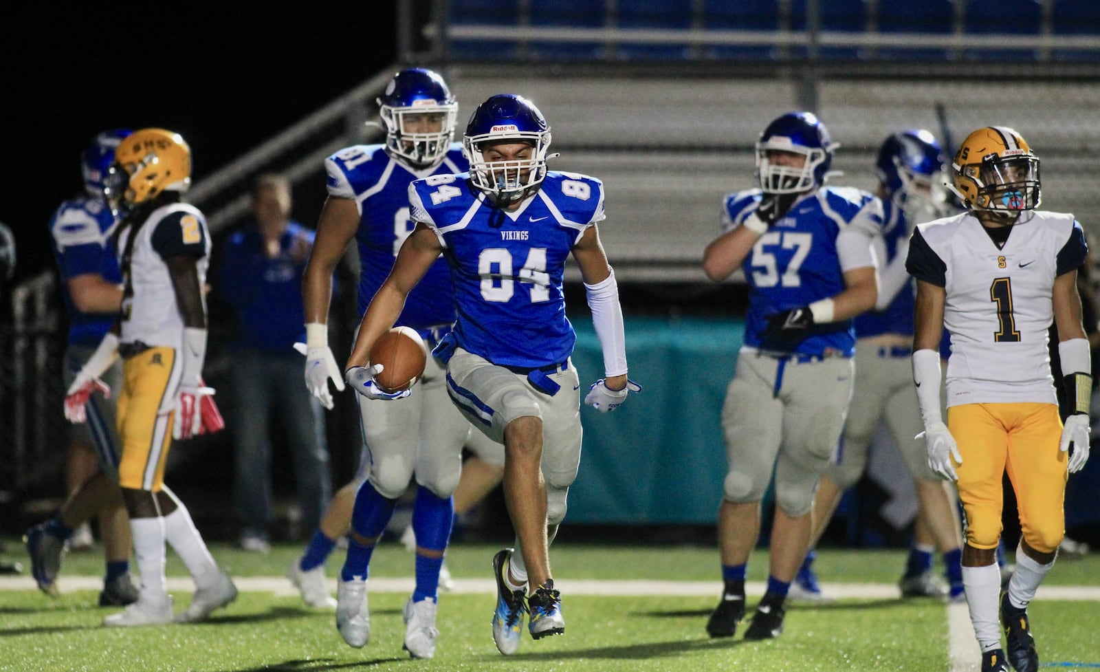 Miamisburg's Jackson McGohan celebrates the first of his three touchdowns against Springfield on Friday, Oct. 15, 2021, at Holland Field in Miamisburg. David Jablonski/Staff