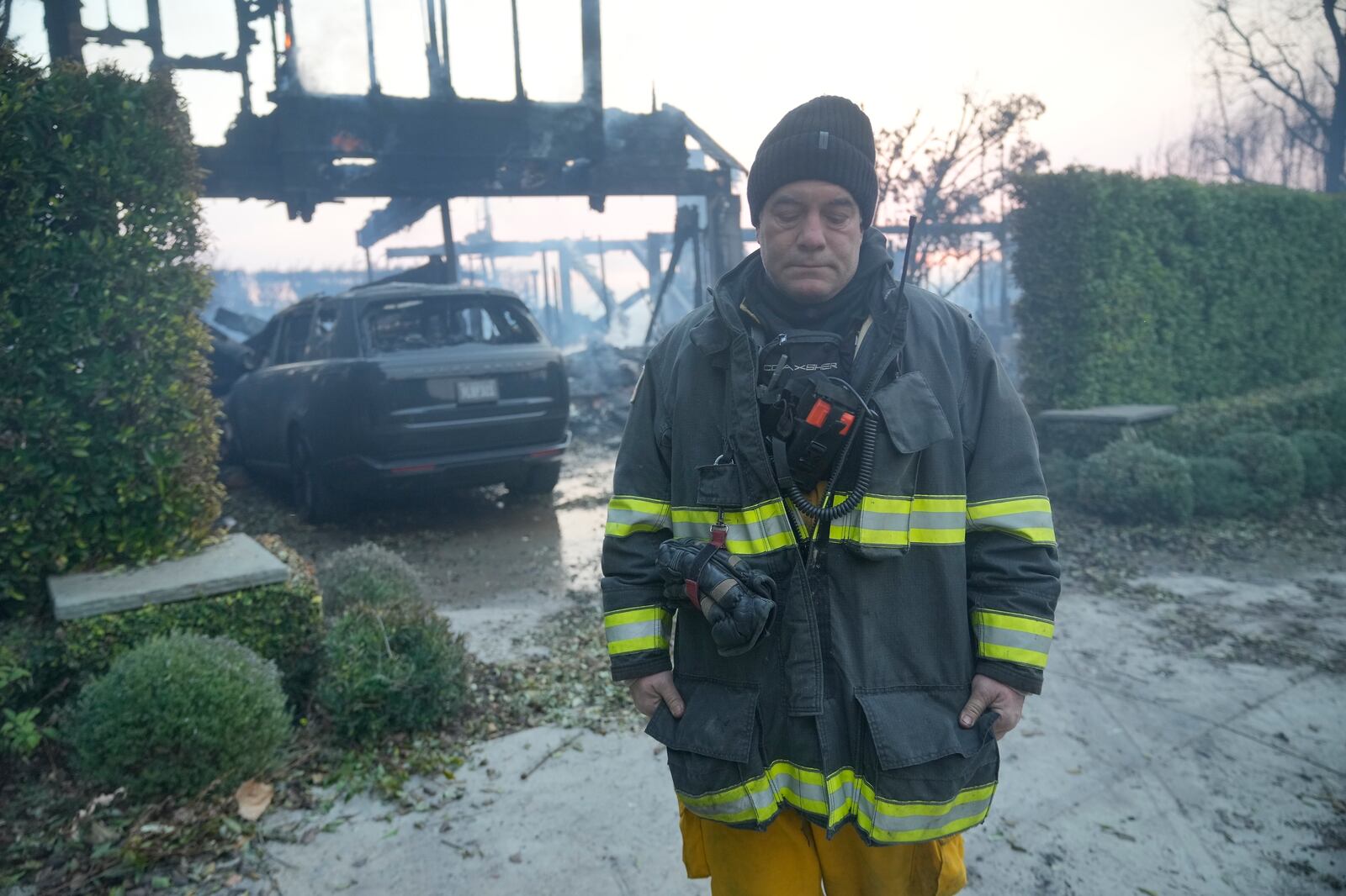 Gilroy Fire Department's Firefighter/Paramedic Kevin Bebee walks away after mopping up the residence fire overnight in Palisades neighborhood of Los Angeles, Thursday, Jan. 9, 2025. (AP Photo/Damian Dovarganes)