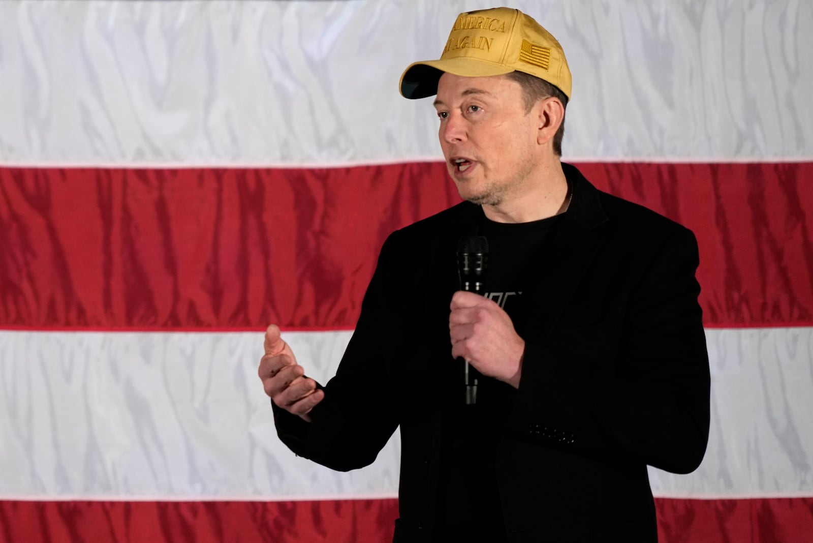 Elon Musk speaks as part of a campaign town hall in support of Republican presidential nominee former President Donald Trump in Folsom, Pa., Thursday, Oct. 17, 2024. (AP Photo/Matt Rourke)