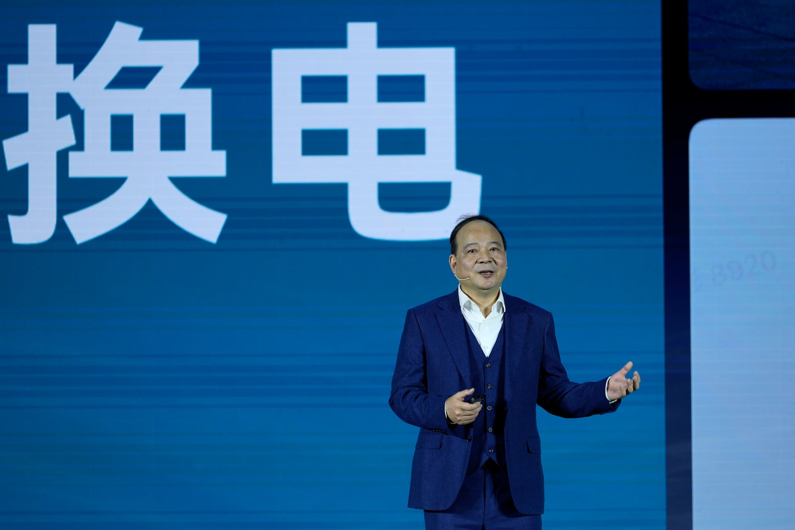 Robin Zeng, the CEO of China-based CATL battery manufacturing company, speaks near the words reads "swap battery" at a launch event for the next generation of swap stations in Xiamen, Fujian province, China, Wednesday, Dec. 18, 2024. (AP Photo/Ng Han Guan)