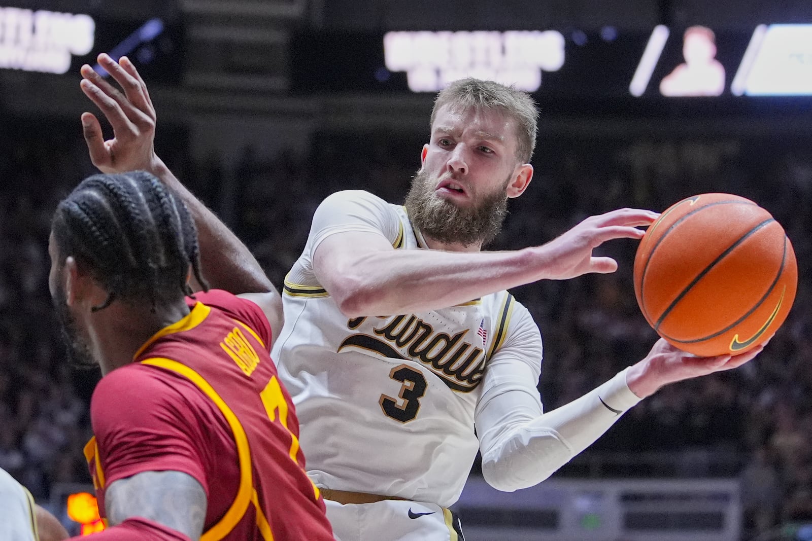 FILE - Purdue guard Braden Smith (3) looks to pass around Southern California guard Chibuzo Agbo (7) during the second half of an NCAA college basketball game in West Lafayette, Ind., Friday, Feb. 7, 2025. (AP Photo/Michael Conroy, File)