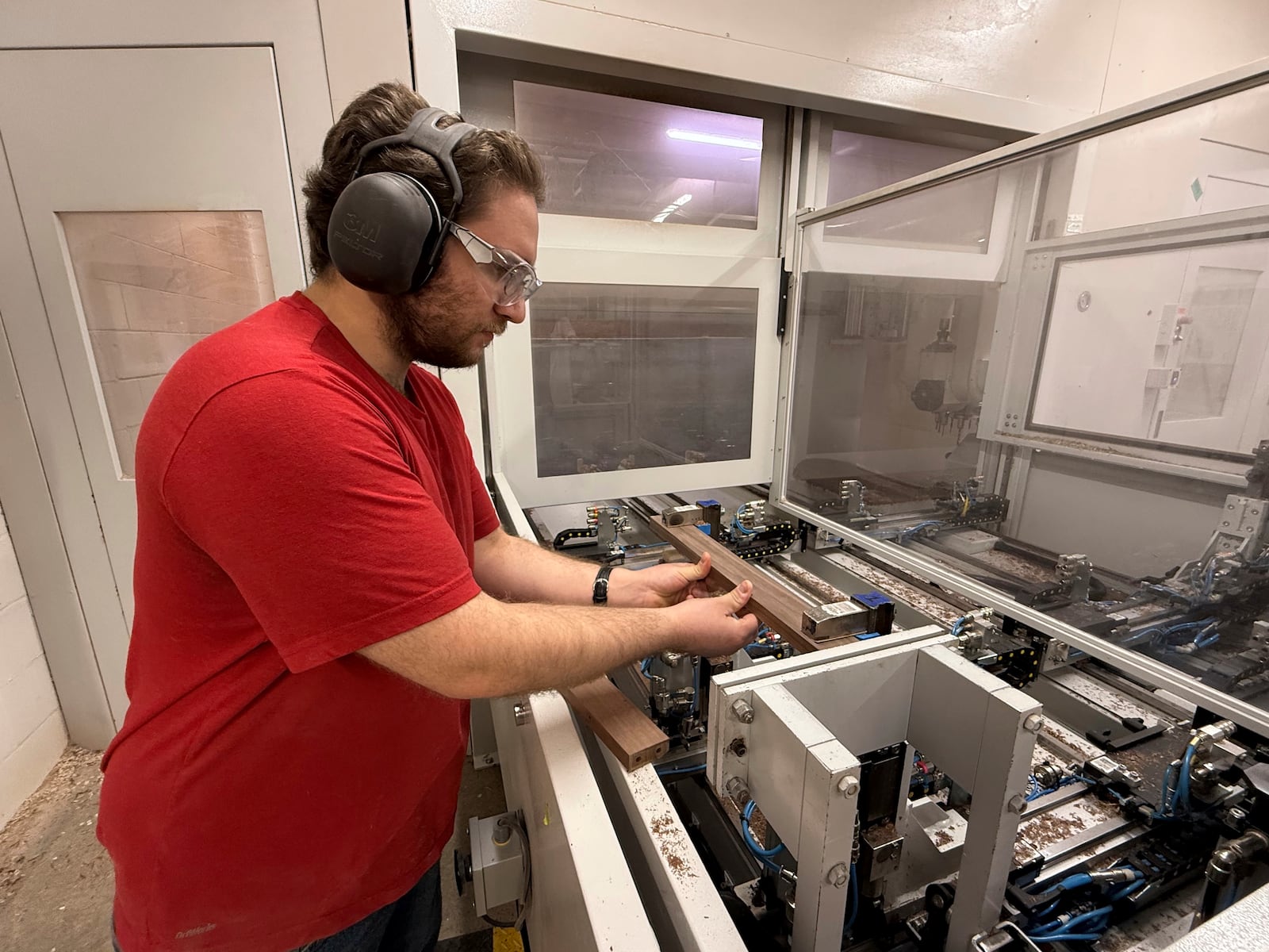 Built by Newport furniture company, employee Nathan Martin machines parts for hardwood furniture after the business's owner, Dave Laforce, who sources material from Canada, attended a roundtable event with U.S. Sen. Peter Welch of Vermont and Marie-Claude Bibeau, a Canadian member of parliament, to discuss the Trump administration's tariffs, Tuesday, March 18, 2025 in Newport, Vt. (AP Photo/Amanda Swinhart)