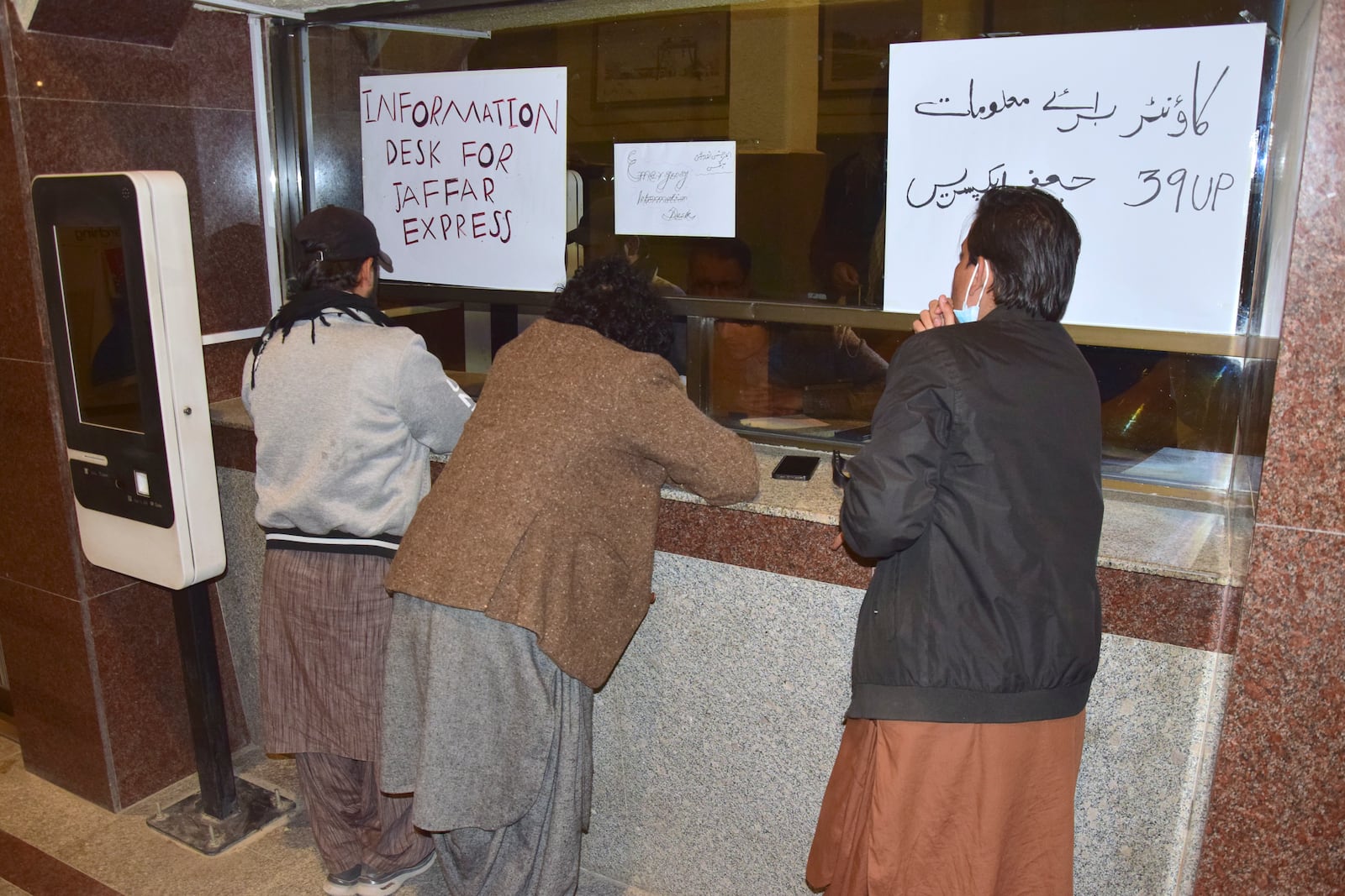 Relatives of passengers of a train, which is attacked by insurgents, get information about passengers from special counter at a railway station in Quetta, Pakistan, Tuesday, March 11, 2025. (AP Photo/Arshad Butt)