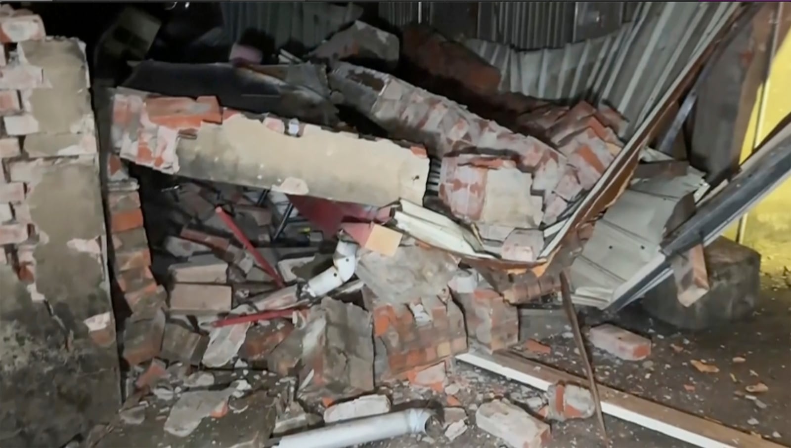 This image from a video, shows debris from a collapsed house in Tainan, Taiwan Tuesday, Jan. 21, 2025, after an earthquake. (TVBS via AP)