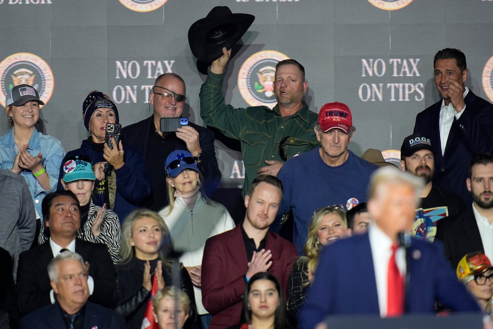 Oath Keepers founder Stewart Rhodes, top row from third left, and Ryan Bundy listen as President Donald Trump speaks about the economy during an event at the Circa Resort and Casino in Las Vegas, Saturday, Jan. 25, 2025. (AP Photo/John Locher)