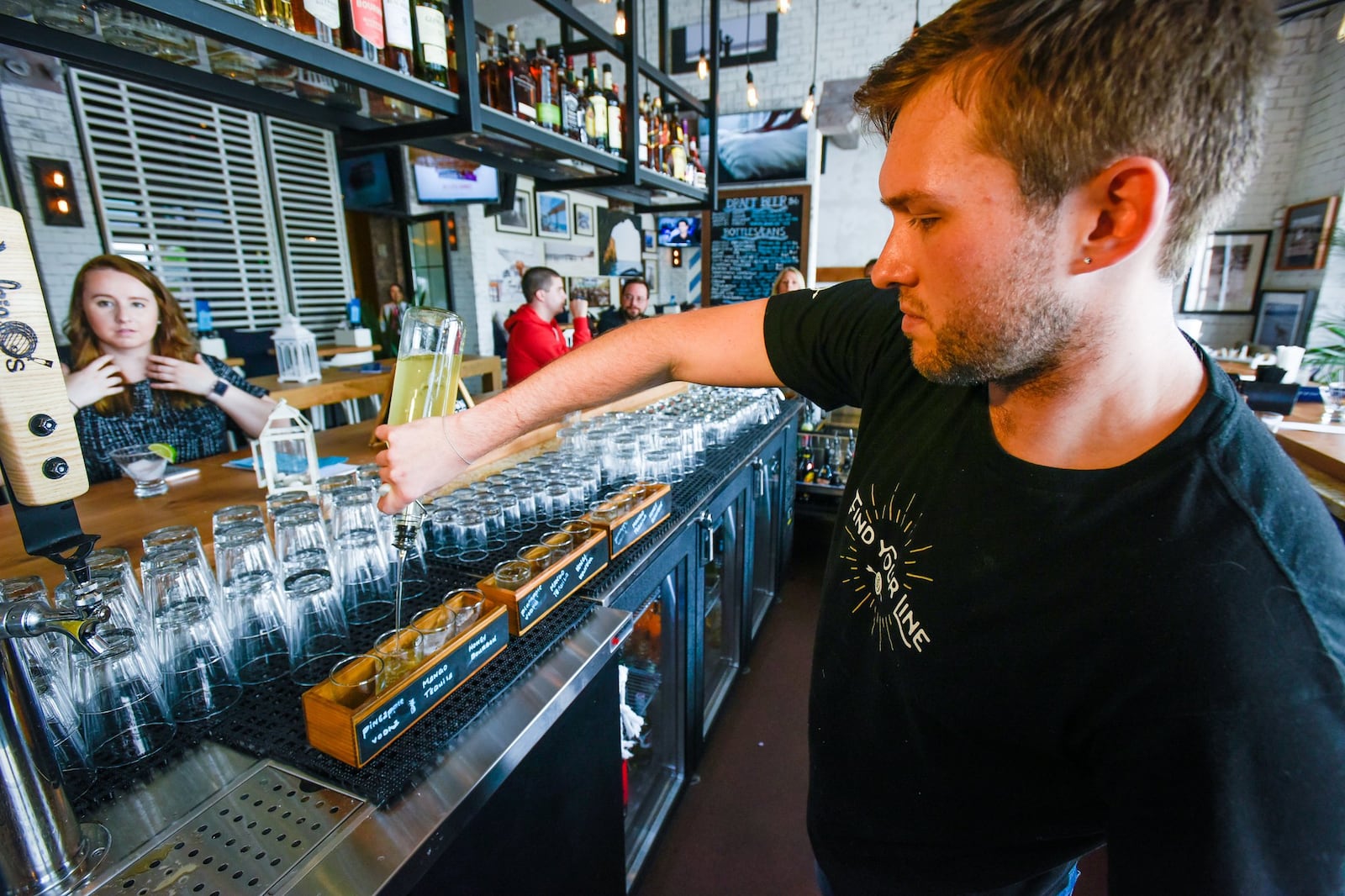 Bartender Brian McCarty makes cocktails at the newly opened Bar Del Mar at Liberty Center in Liberty Twp. 