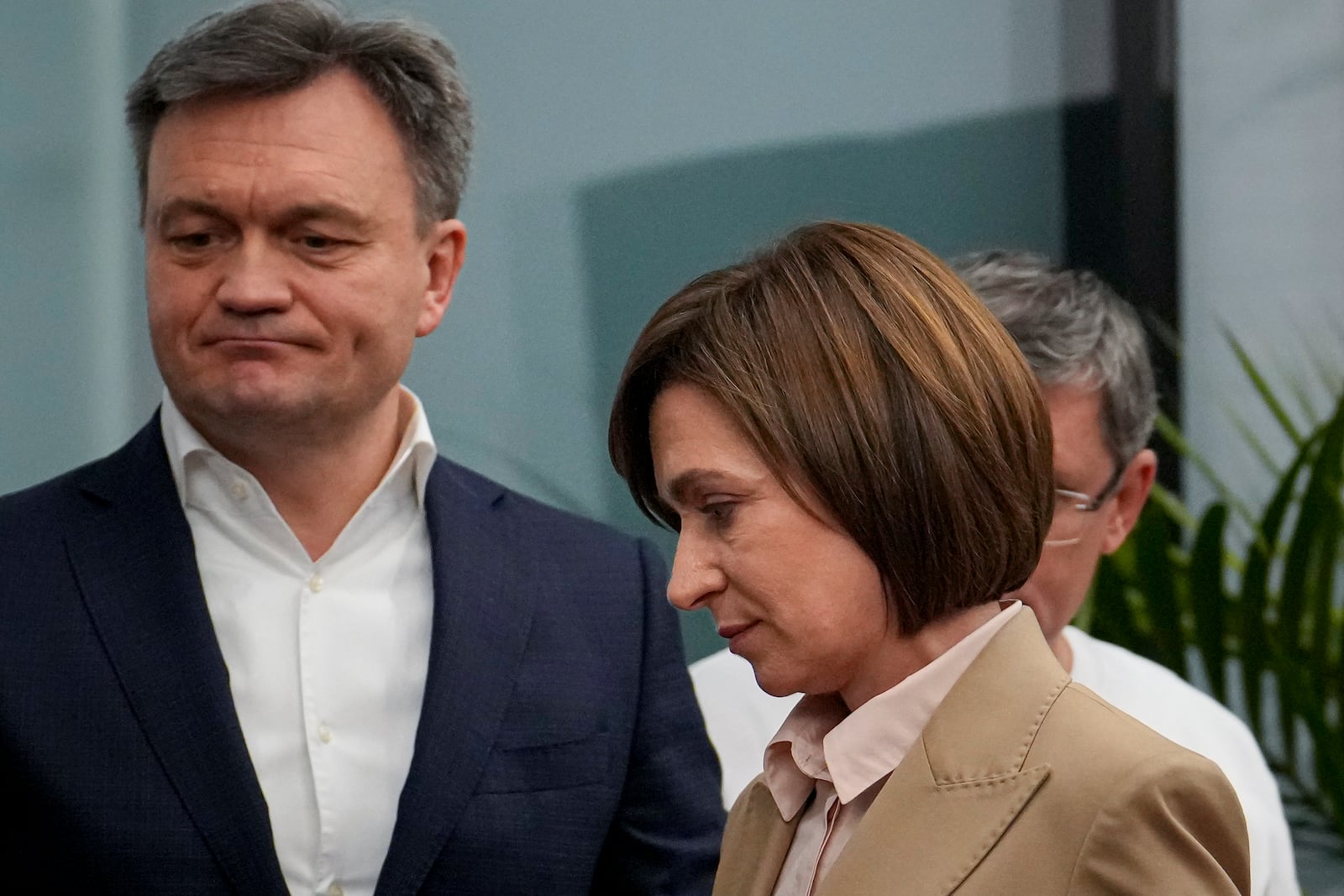 Moldova's President Maia Sandu, right, walks by Moldova's Prime Minister Dorin Recean, left, after the polls closed for the presidential election and the referendum on whether to enshrine in the Constitution the country's path to European Union membership, in Chisinau, Moldova, Monday, Oct. 21, 2024. (AP Photo/Vadim Ghirda)