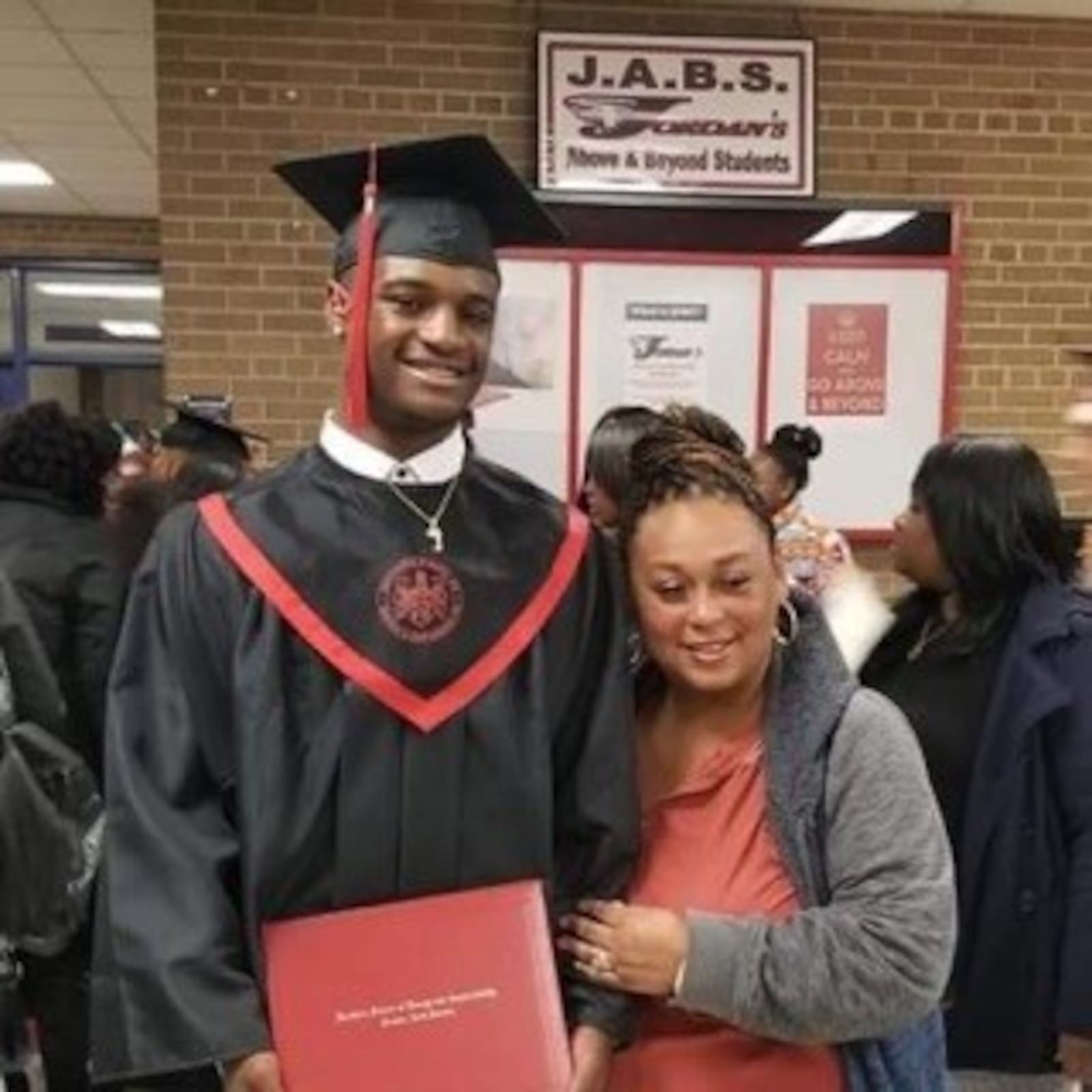 Jacquez Warren at his graduation from South Durham High in North Carolina with his legal guardian Michelle Hunt, whom he considers a second mom, as he does his aunt Lekendra Warren.  CONTRIBUTED