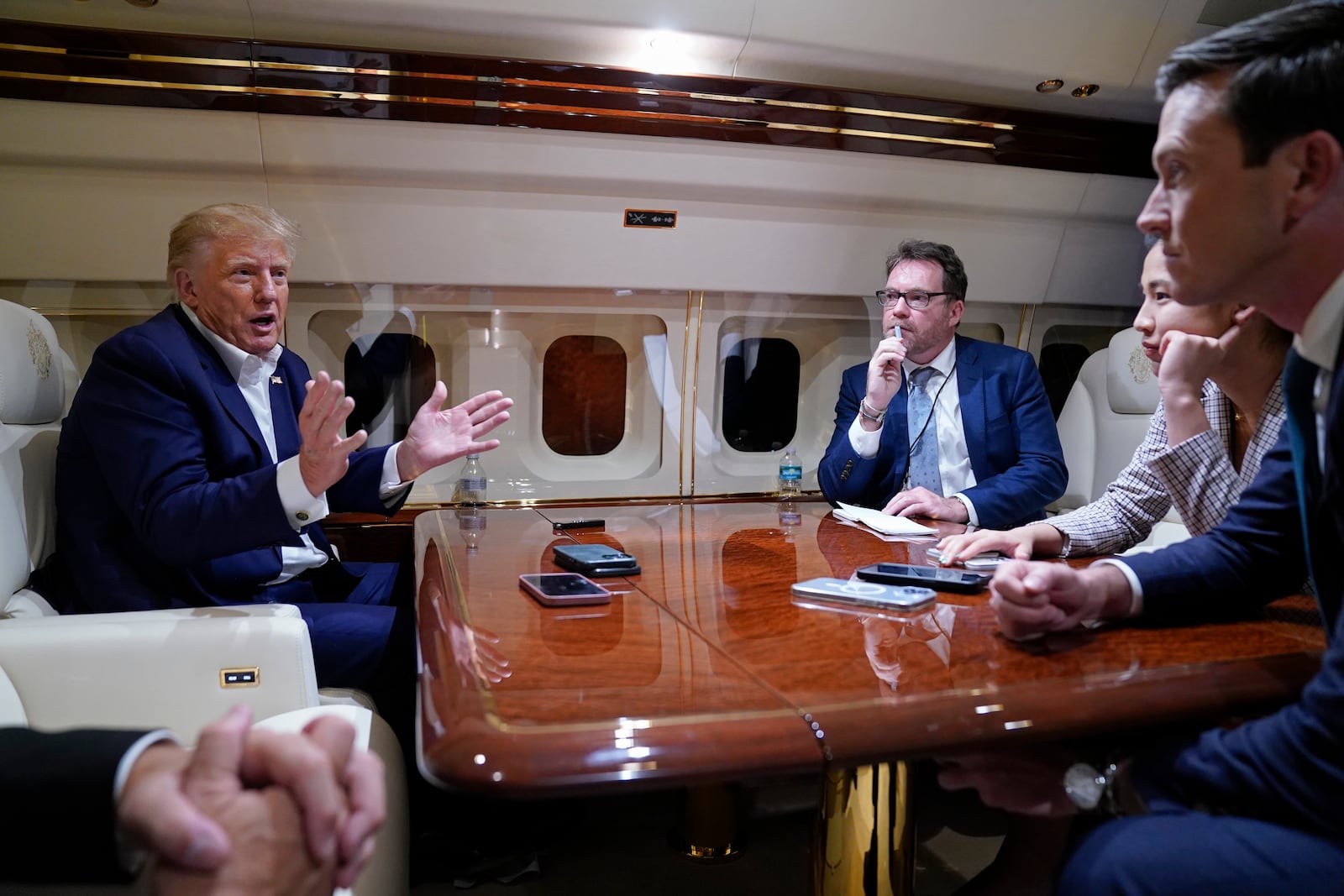 FILE - Republican presidential nominee, former President Donald Trump speaks with reporters while in flight on his plane o West Palm Beach after attending a campaign rally in Waco, Texas, March 25, 2023. (AP Photo/Evan Vucci, File)